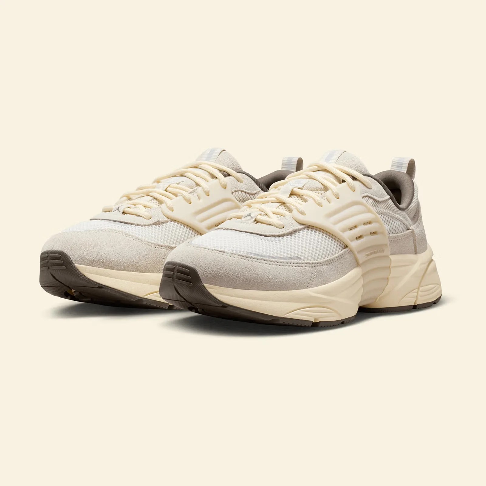 A pair of Jordan Trunner O/S sneakers in Phantom shown at an angle with the toes pointing to the left corner