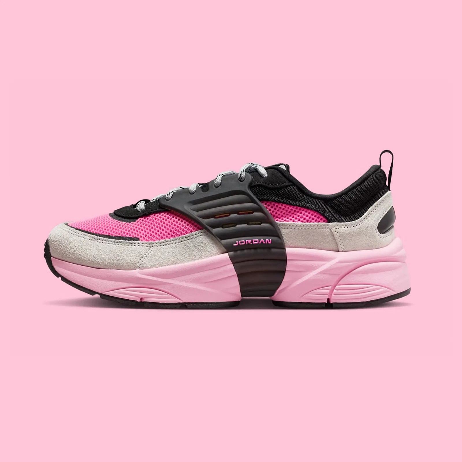 A single Jordan Trunner O/S sneaker shown in profile with the toe pointing to the left of the image frame in the "Pink Blast" color way, which is a mixture of black, neon pink, bubble gum pink and grey. The shoe is shown against a light pink background.