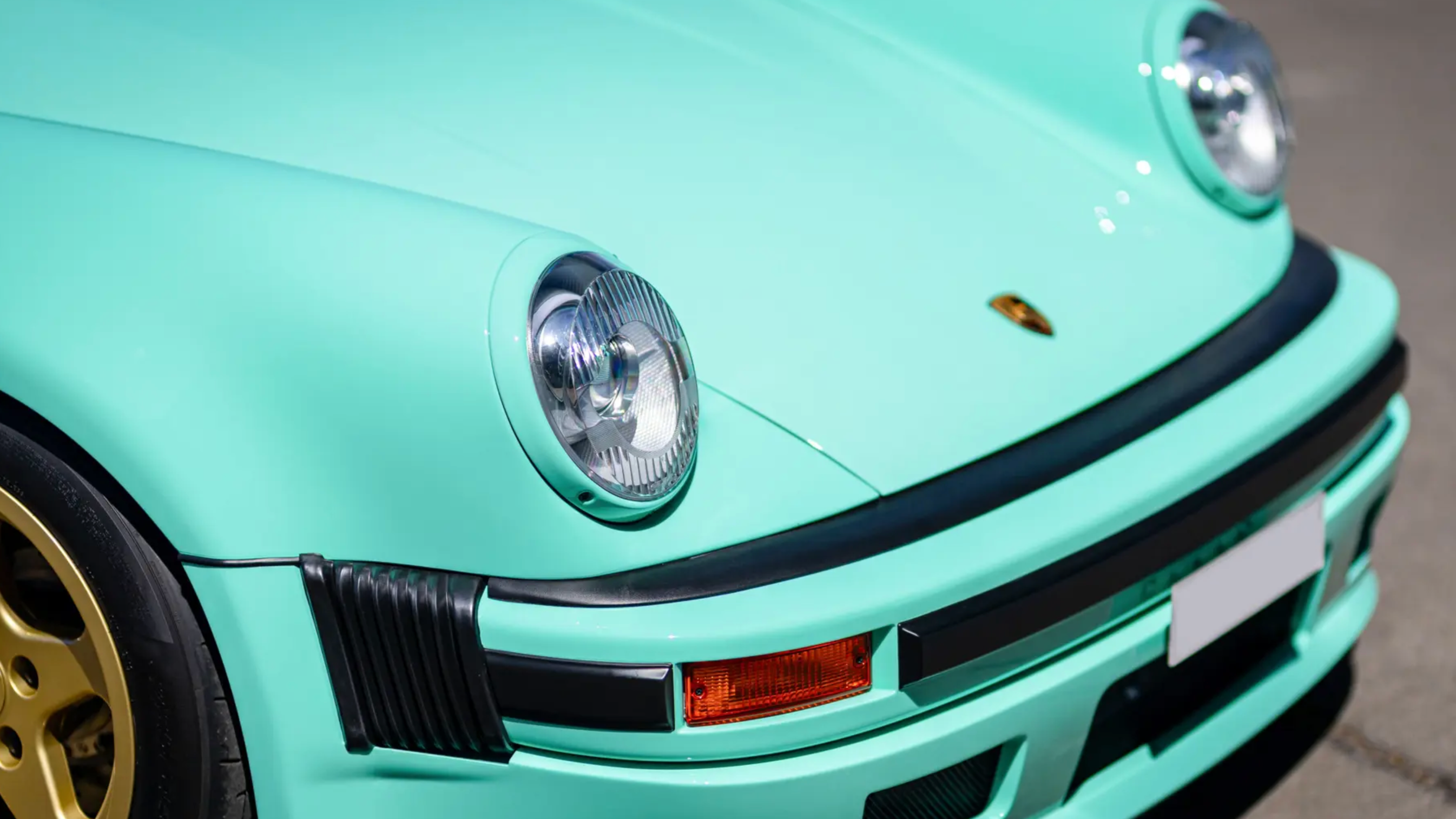 a close-up photo of the headlights and grille from a classic porsche 911