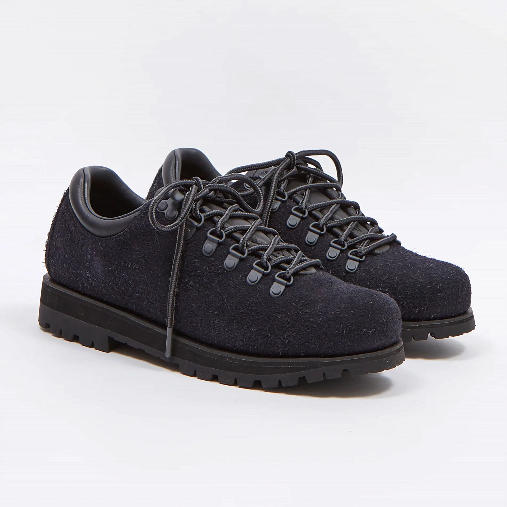 Pair of black textured hiking-style shoes with thick rubber soles, round toes, and black laces threaded through metal eyelets and hooks. The shoes have padded collars and a rugged, durable design.
