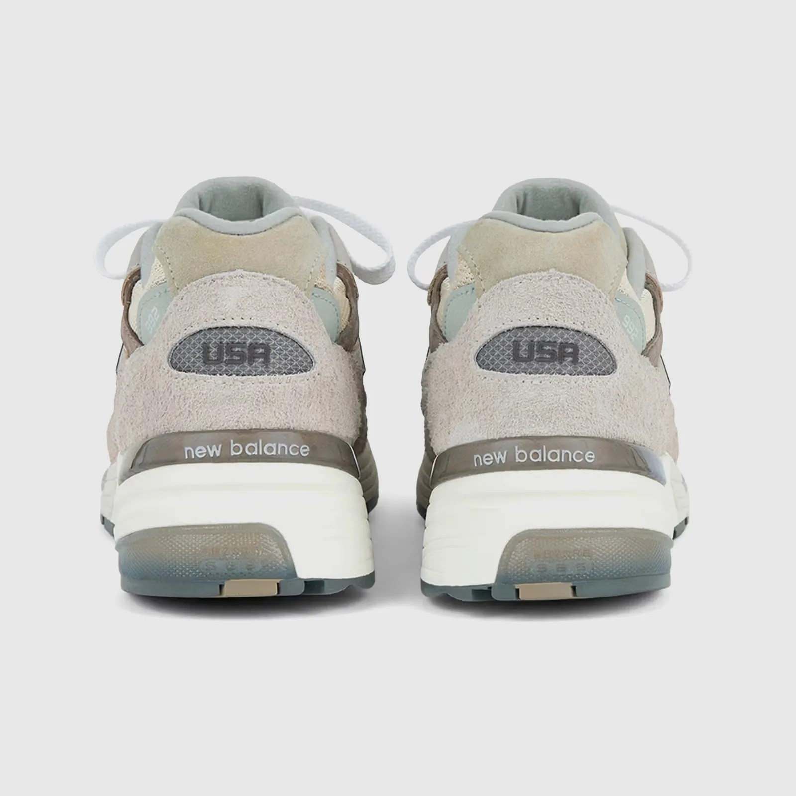 A pair of New Balance 992 sneakers shown from the heel on. 