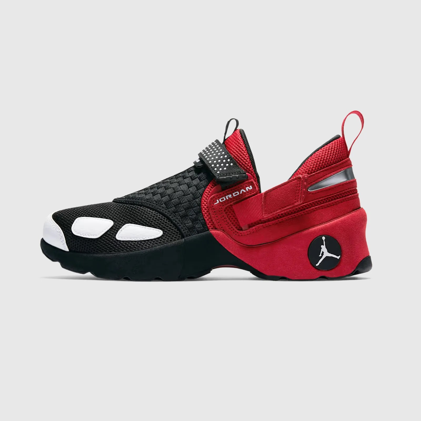A single Jordan Trunner LX OG in red and black shown in profile with the toe pointing to the left edge of the image frame. 