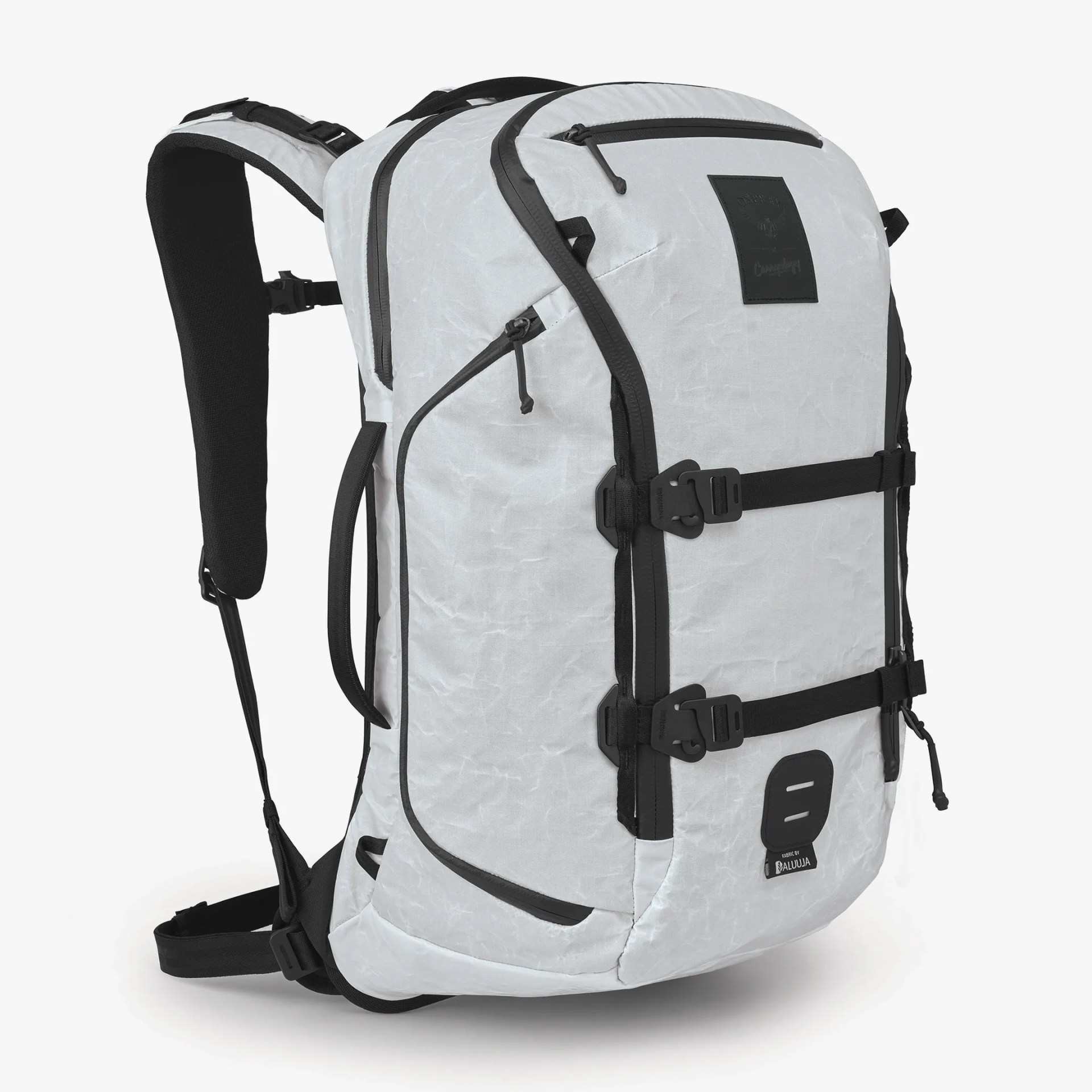 White and black backpack with multiple zippered compartments, adjustable padded shoulder straps, side handle, and two black horizontal buckle straps on the front. The material has a slightly crinkled texture.