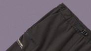 Black Patagonia pants with an elastic waistband and an adjustable buckle strap. The pants feature a zippered pocket on the side and the Patagonia logo printed near the pocket. The fabric appears smooth and slightly matte.