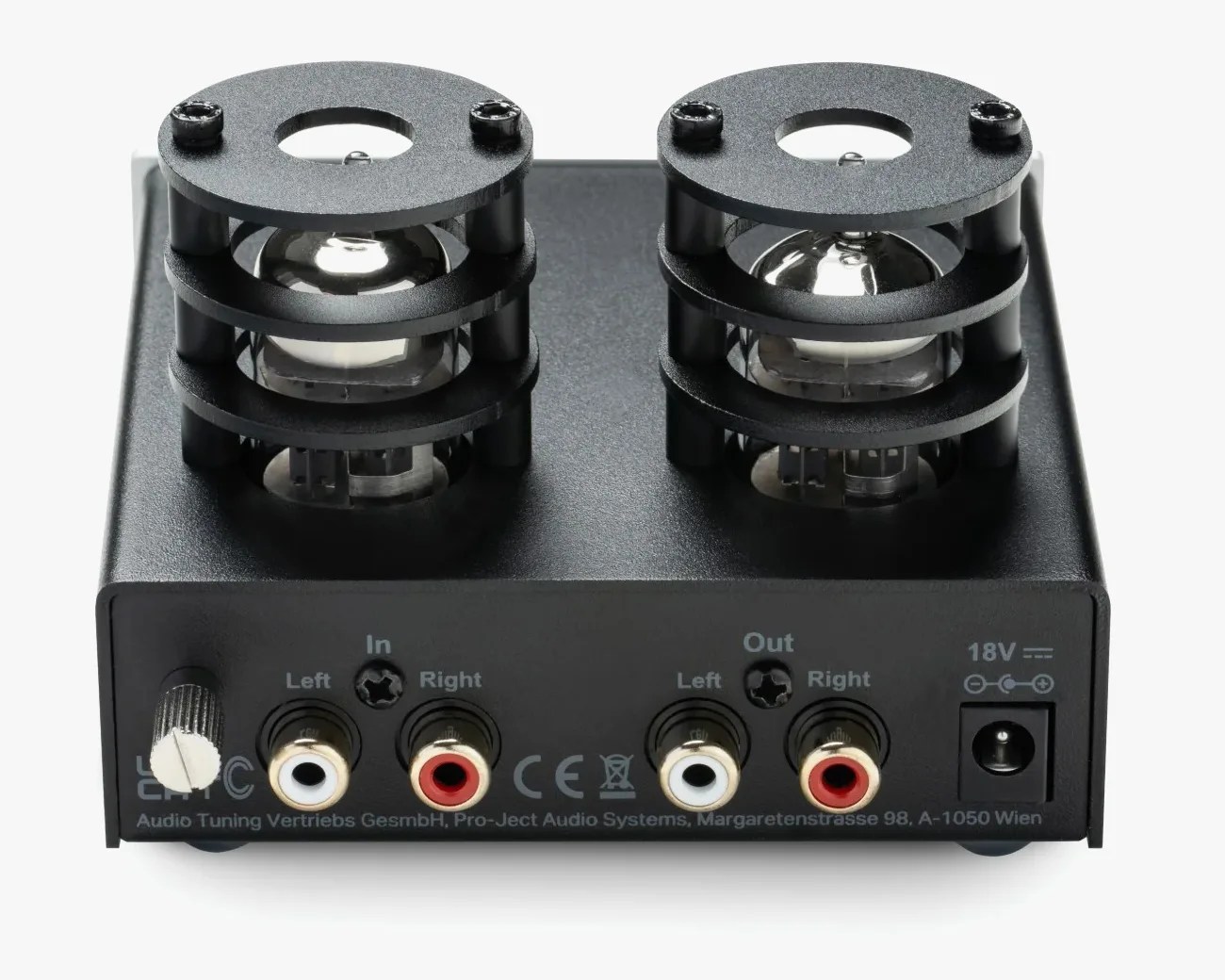 Compact black audio device with two visible vacuum tubes protected by circular black metal cages on top. The front panel features a silver knob on the left, two pairs of RCA input and output connectors labeled "Left" and "Right," and a power input labeled "18V." Text on the front includes "Audio Tuning Vertriebs GesmbH, Pro-Ject Audio Systems, Margaretenstrasse 98, A-1050 Wien.