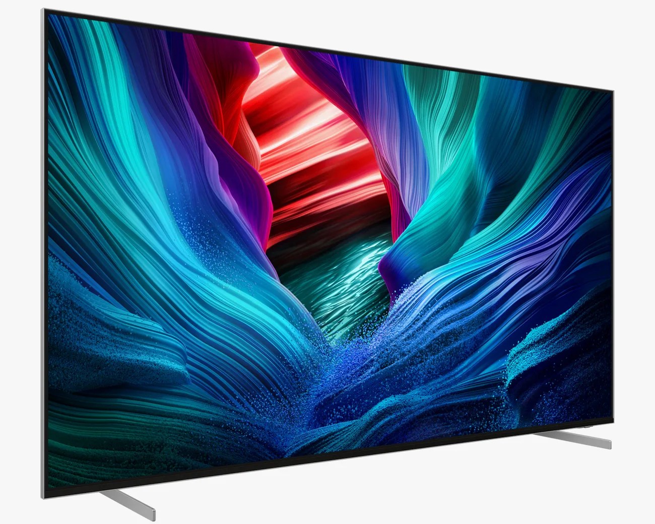 A modern flat-screen television with thin black bezels and two slim silver legs, displaying a vibrant abstract image featuring flowing, wave-like patterns in shades of blue, teal, purple, and red.