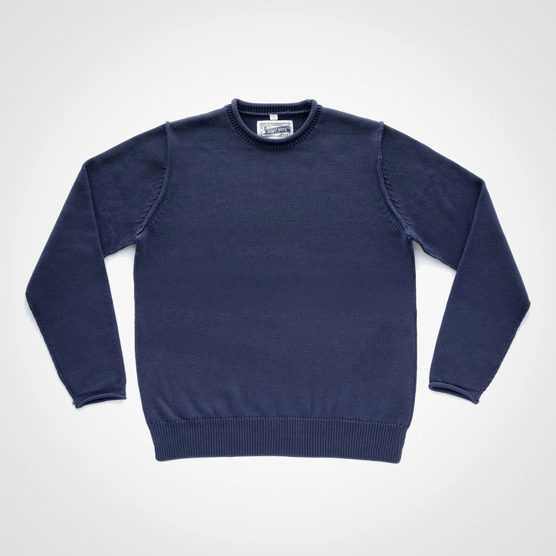 Navy blue crewneck sweater with long sleeves and ribbed cuffs and hem, laid flat on a white background.