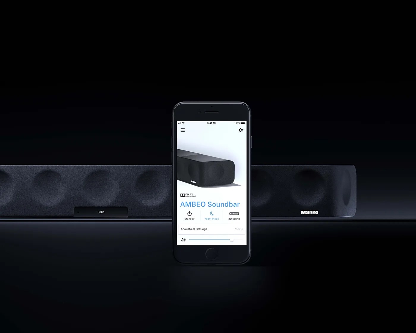 A black AMBEO soundbar is displayed against a dark background with a smartphone in front showing the AMBEO Soundbar control app. The app screen features options like Standby, Night mode, 3D sound, and acoustical settings with a volume slider. The soundbar has a fabric front with circular speaker outlines and an AMBEO logo on the right side.