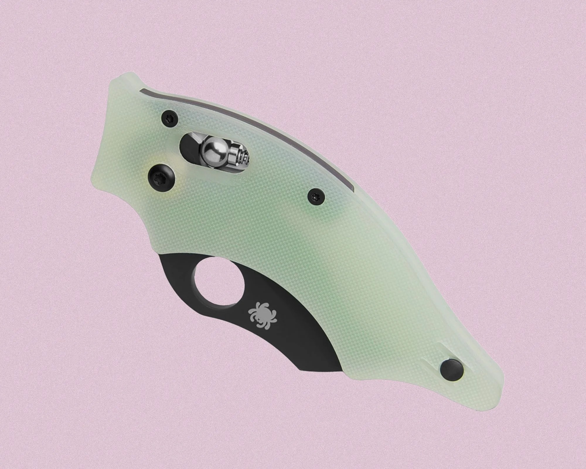Compact folding knife with a translucent light green textured handle and a black section featuring a circular finger hole and a small spider logo. The knife is closed, showing a visible metal locking mechanism near the top.