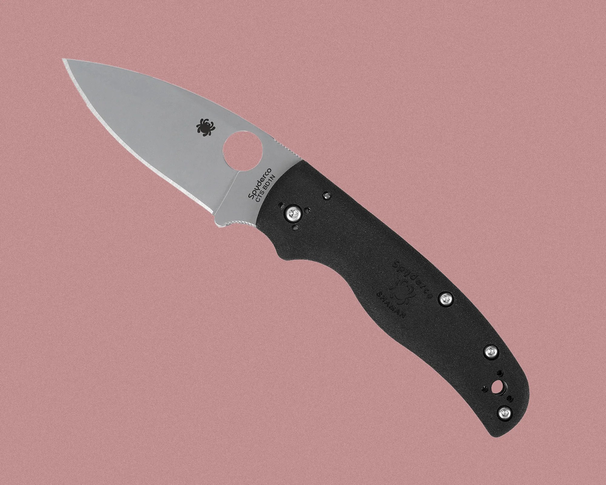 Folding knife with a stainless steel blade and a black textured handle. The blade features a round hole near the base and has the Spyderco logo and "Spyderco CTS BD1N" printed on it. The handle has ergonomic curves and is secured with multiple screws. The background is a muted pink color.