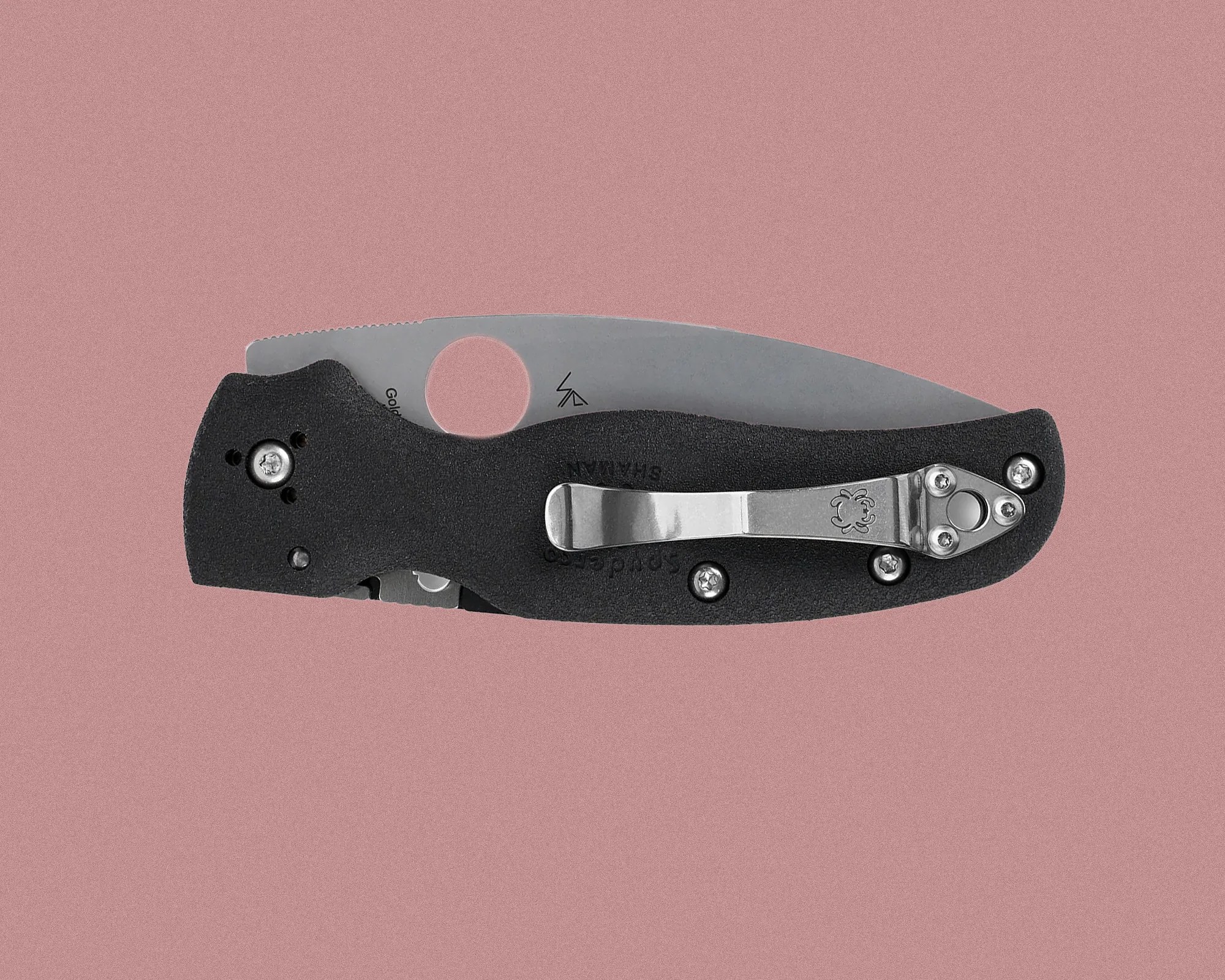 Black folding pocket knife with a stainless steel blade, a circular thumb hole near the base of the blade, and a metal clip attached to the handle. The handle has a textured surface and is secured with multiple screws.