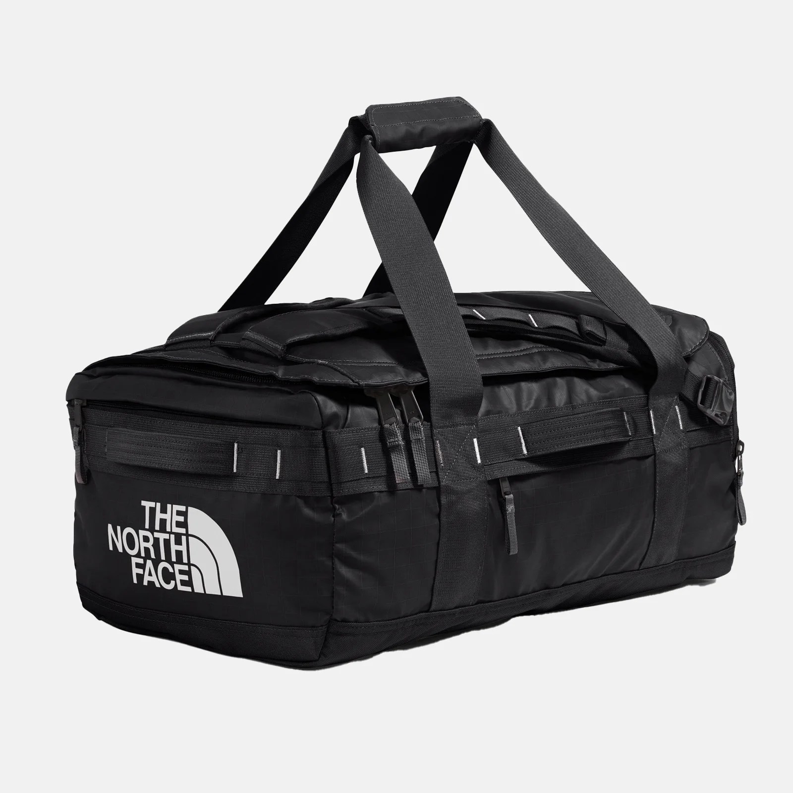 Black rectangular duffel bag with dual handles and a padded grip, featuring "The North Face" logo in white on one end. The bag has multiple zippers and reinforced stitching along the edges and handles.
