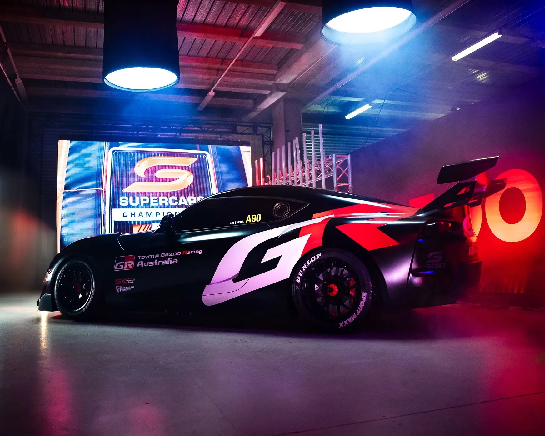 a rear 3/4 photo of a black toyota supra race car