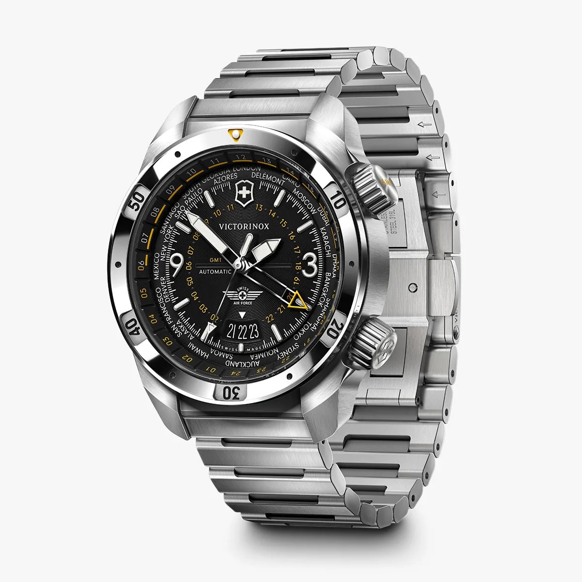 Stainless steel Victorinox wristwatch with a black dial featuring multiple time zones, a date display at 6 o'clock, luminous hands and markers, and two crowns on the right side. The watch has a rotating bezel with minute markers and a stainless steel link bracelet.