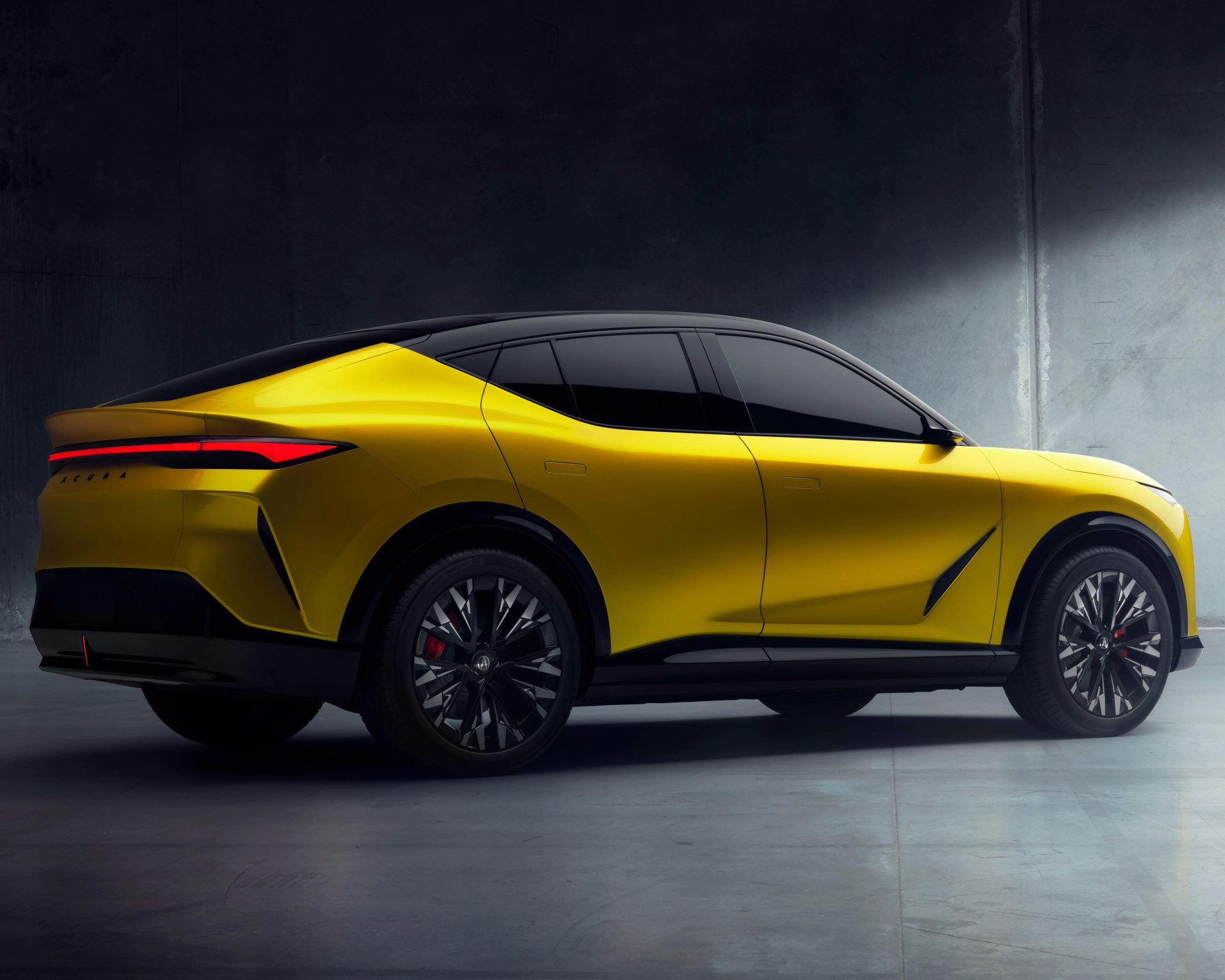 Sleek yellow Acura SUV with a black roof and tinted windows, featuring sharp, angular design lines and modern black alloy wheels with red brake calipers, set against a dark, industrial background.