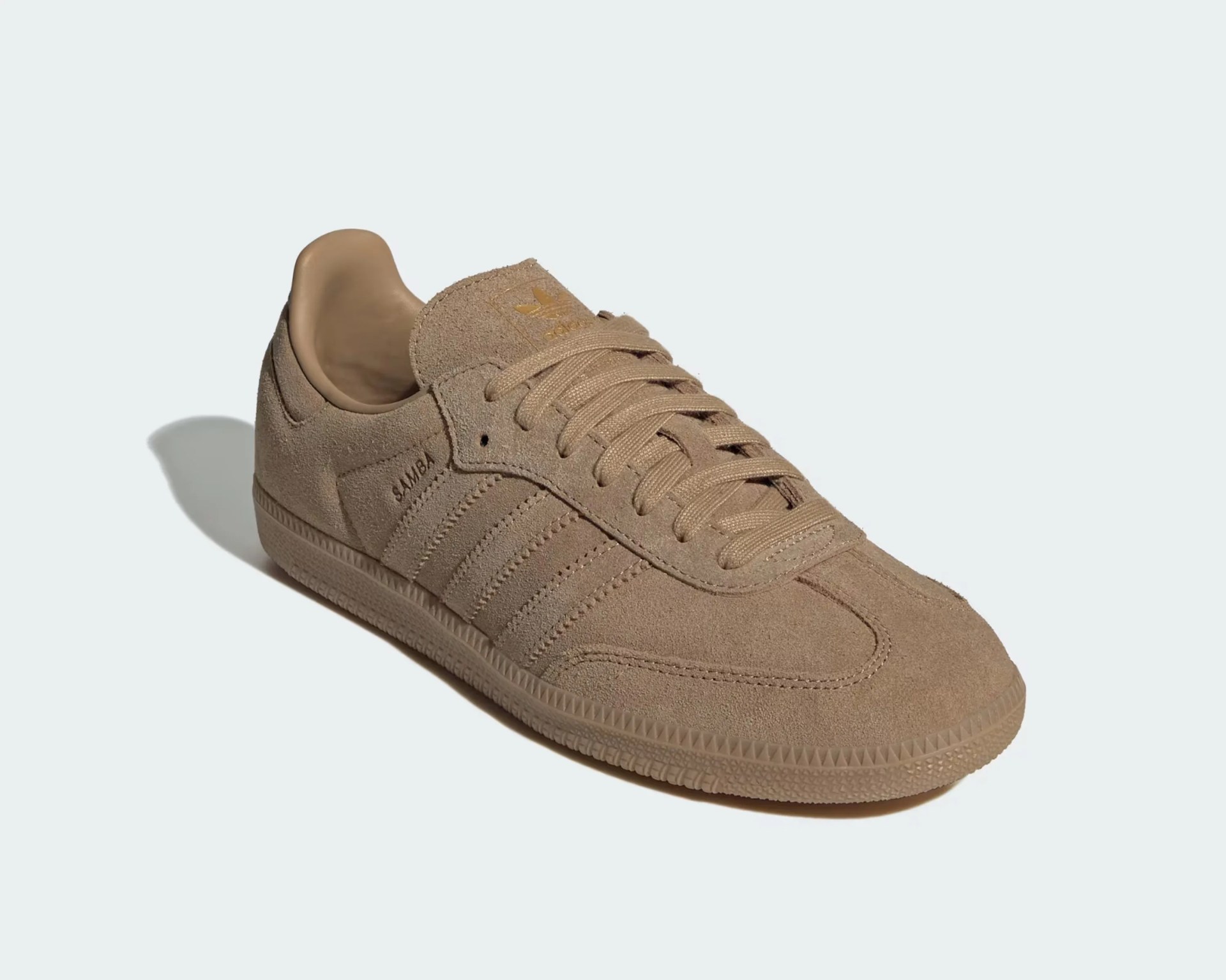 Light brown suede Adidas Samba sneaker with matching laces, textured sole, and the word "SAMBA" embossed on the side.