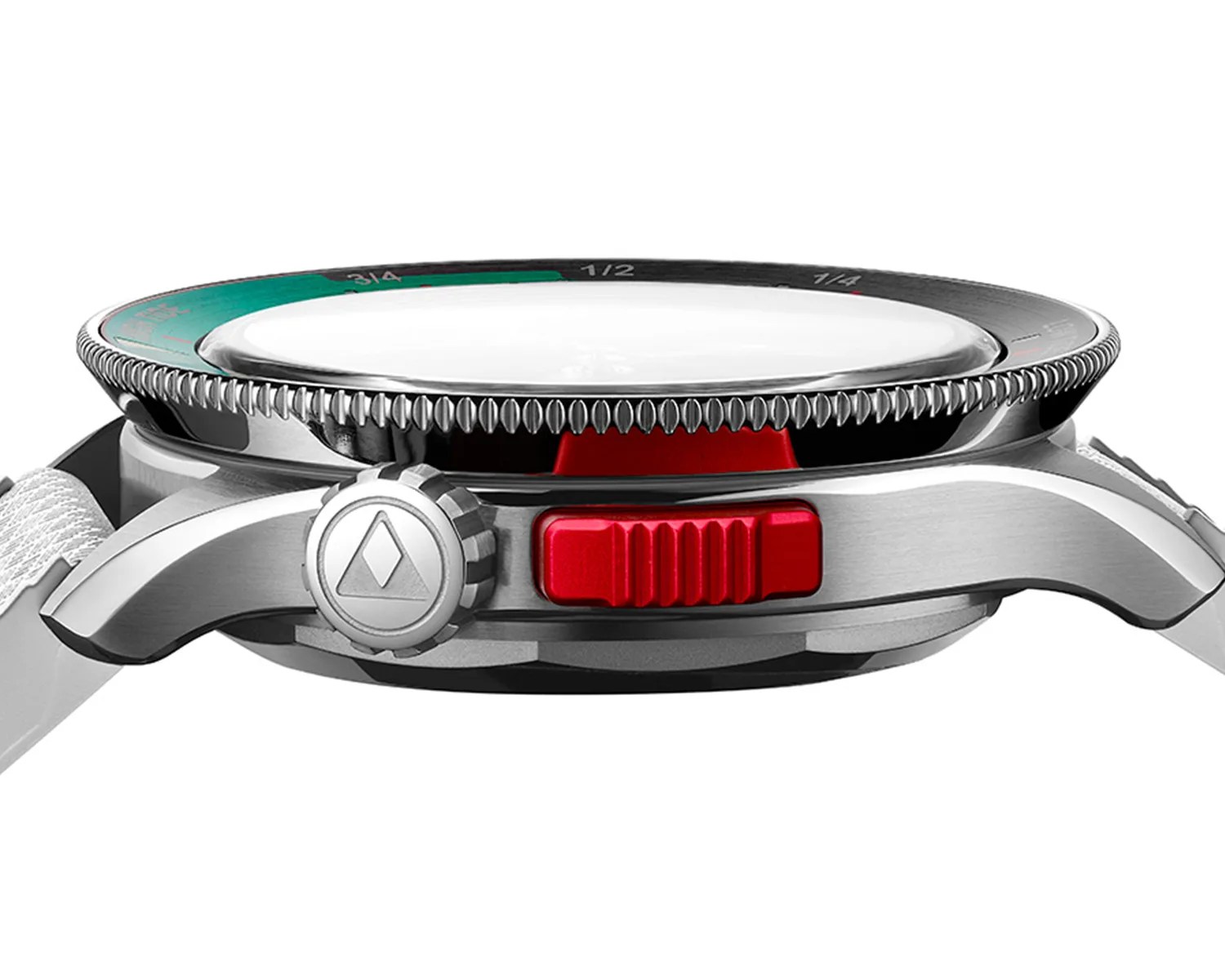 Side view of a wristwatch with a brushed stainless steel case, a textured silver crown featuring a triangular logo, and a prominent red rectangular button next to the crown. The watch has a thick, domed crystal and a black bezel with green and black markings, including fractional numbers like 3/4, 1/2, and 1/4. The strap appears to be white fabric or nylon.