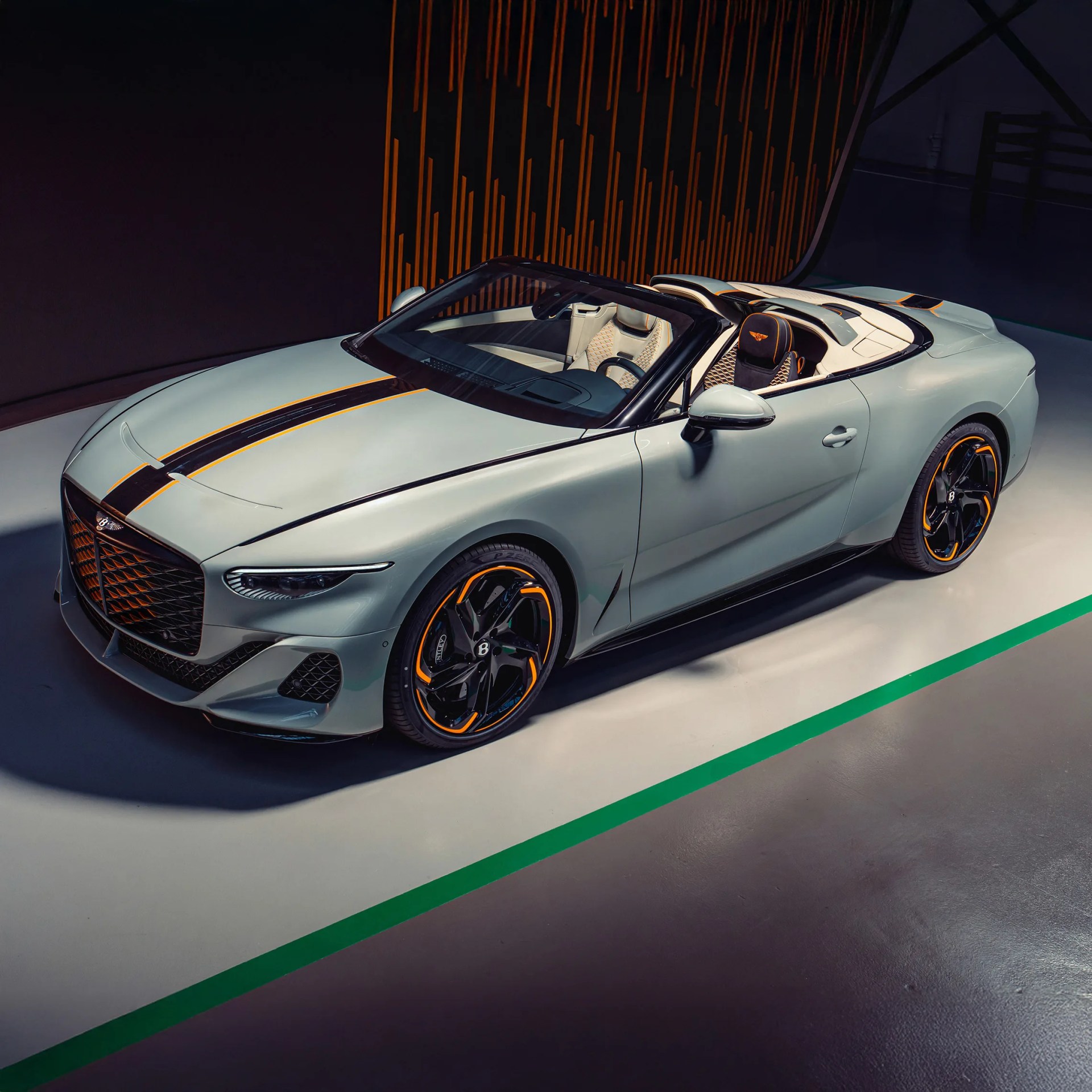 a photo of a white custom bentley convertible on a studio backdrop
