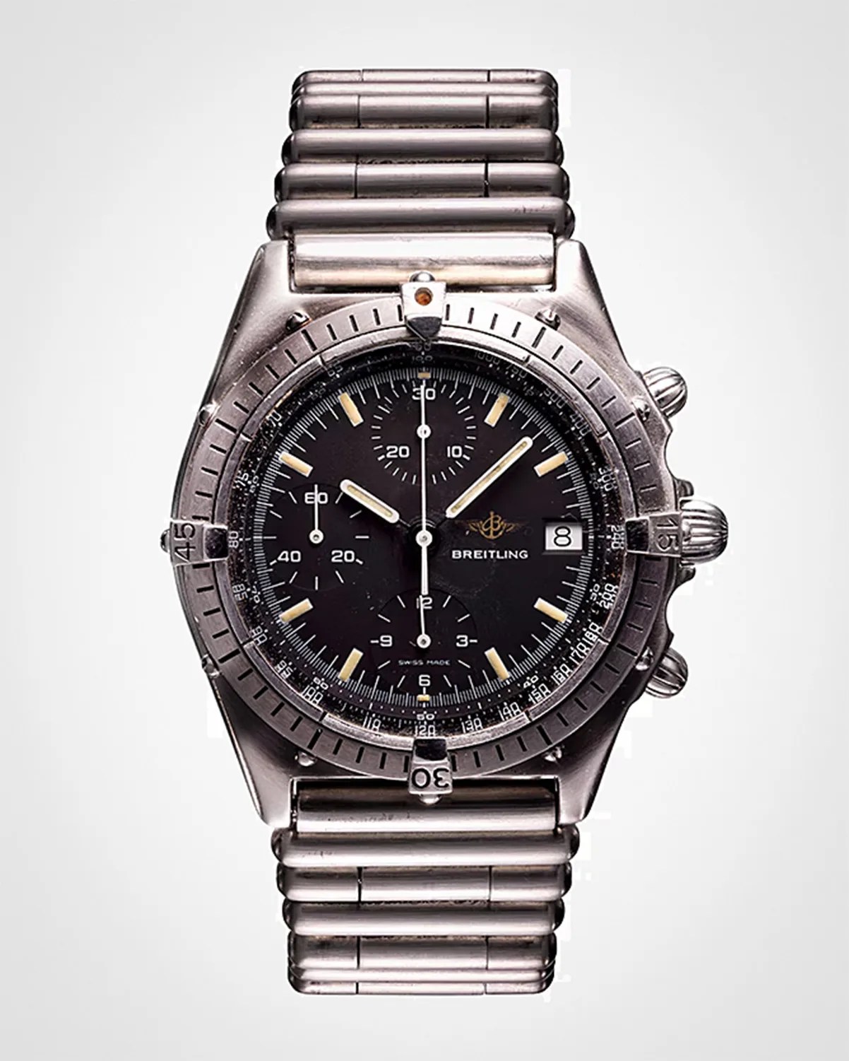 Breitling wristwatch with a black dial, silver hour markers, and three subdials. It features a date window at the 3 o'clock position and a rotating bezel with minute markings. The watch has a stainless steel case and a matching metal link bracelet.