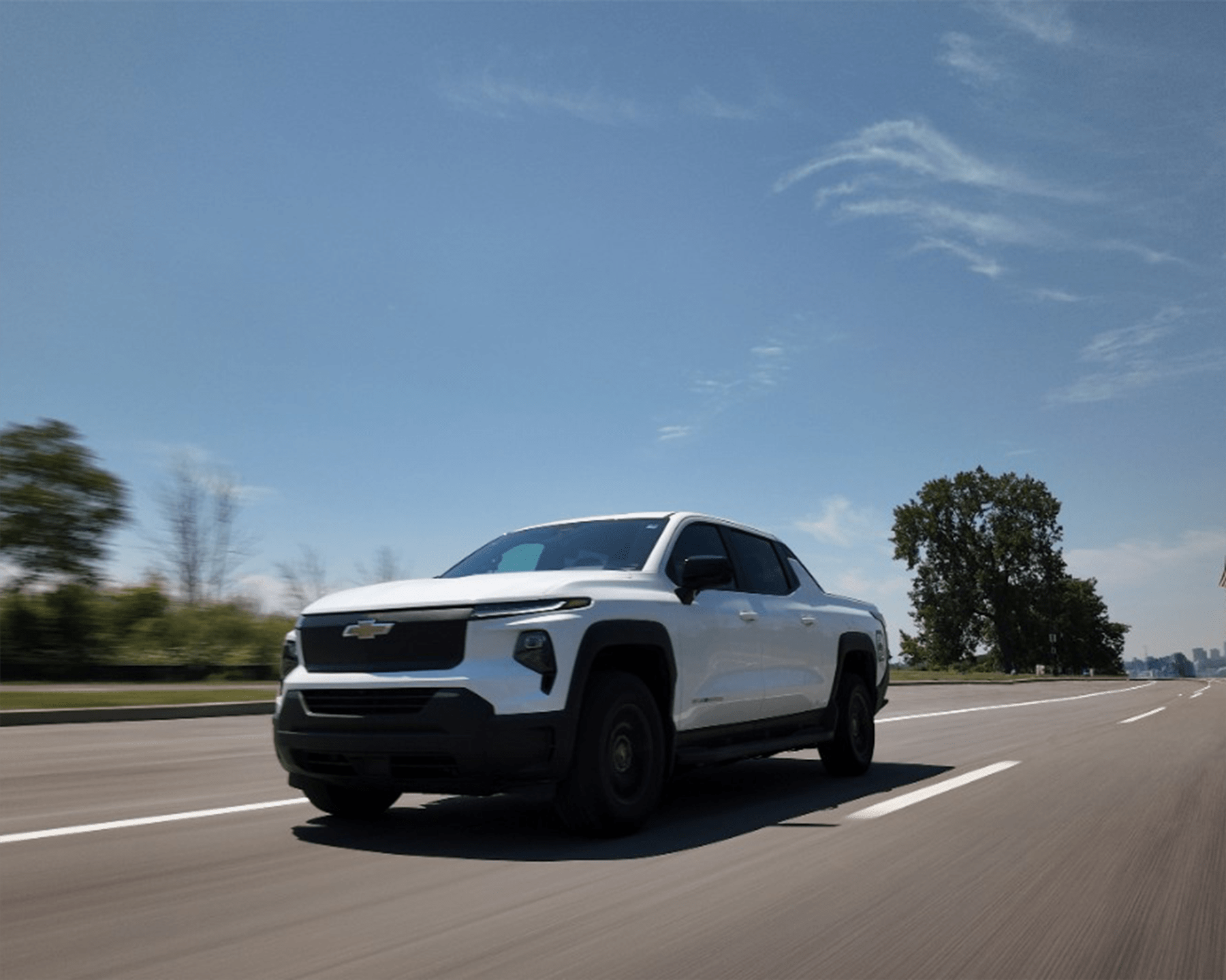 a photo of an electric chevrolet truck driving on a highway