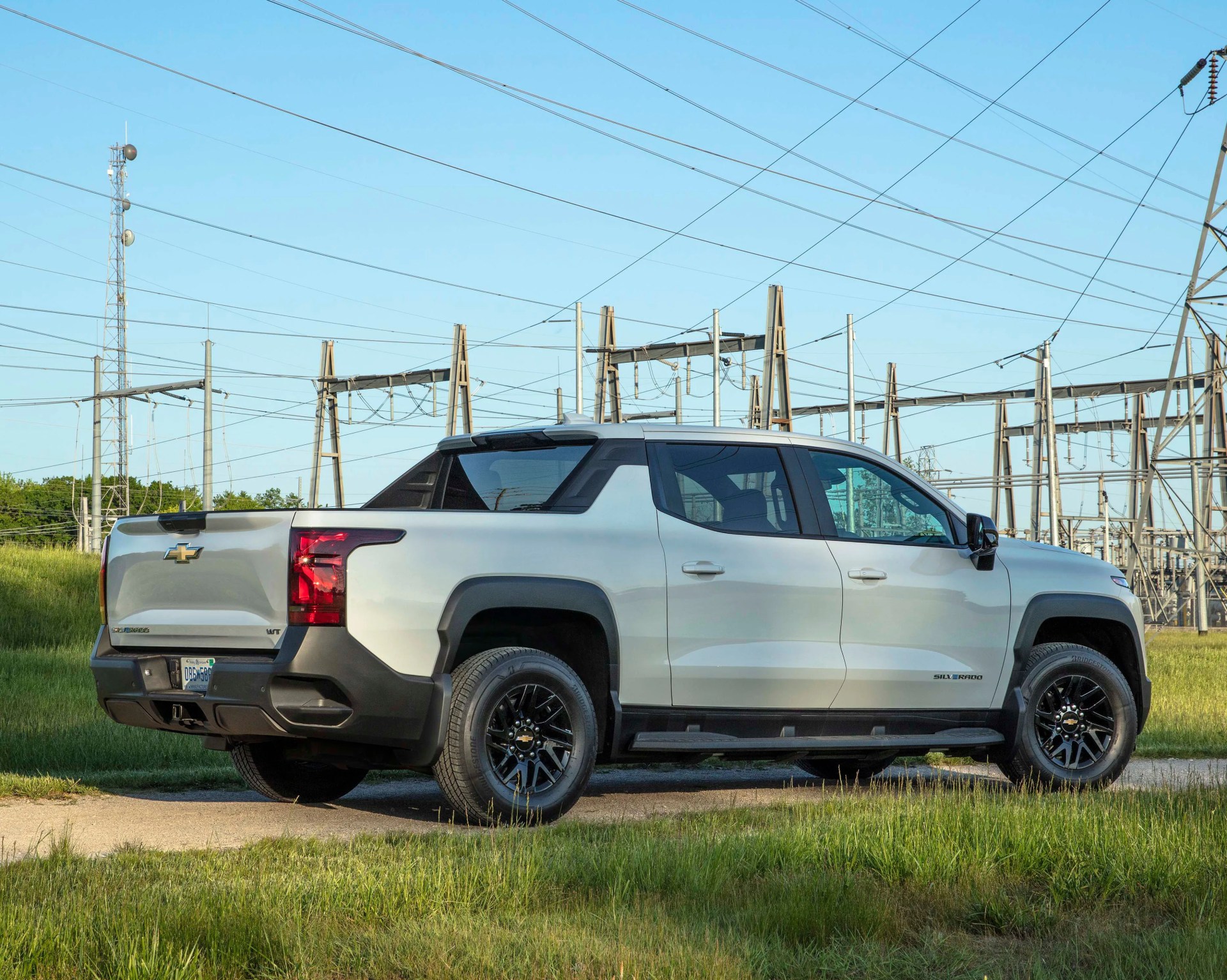 a photo of a chevolet electric truck parked in front of power lines