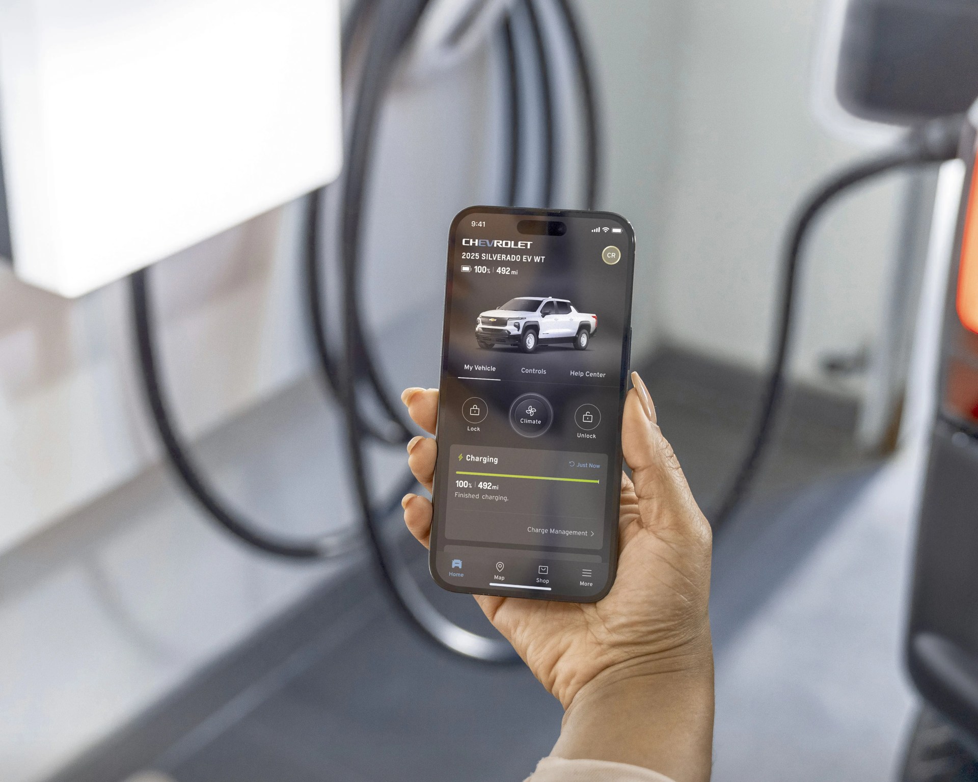 a photo of a hand holding a phone showing silverado EV range