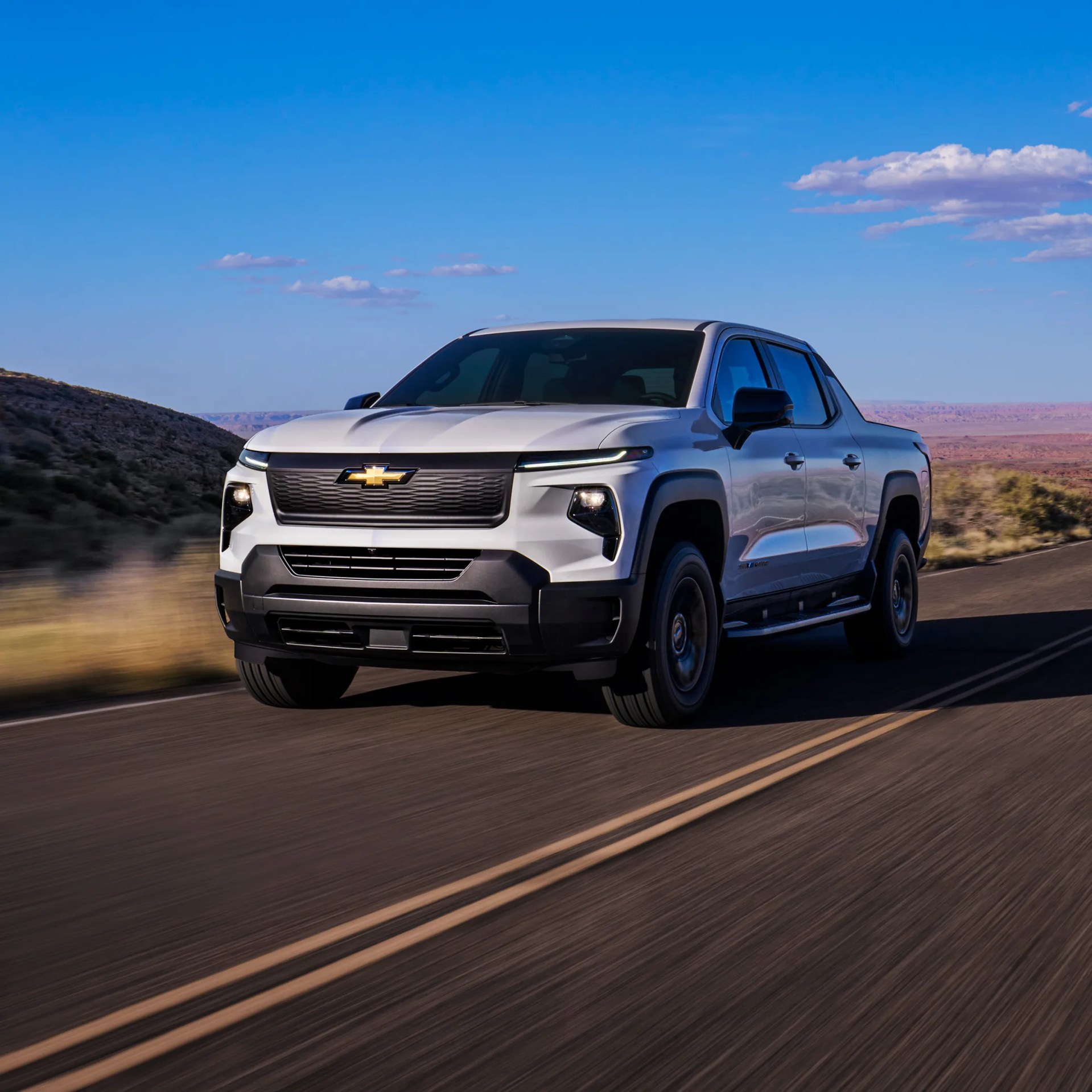 a photo of a chevrolet silverado electric truck driving