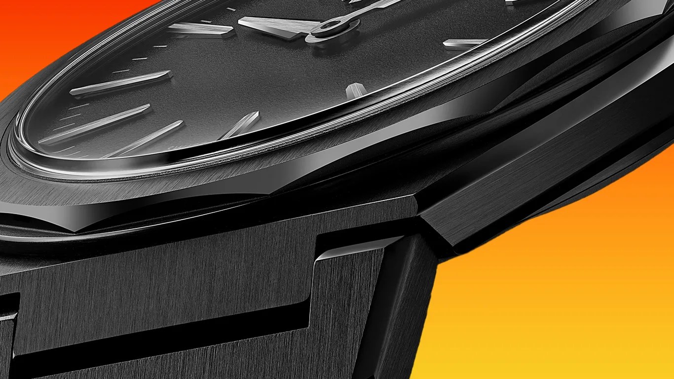 Close-up of a black christopher ward wristwatch with a textured dial, silver hour markers, and hands, featuring a brushed metal case and integrated bracelet against an orange gradient background.
