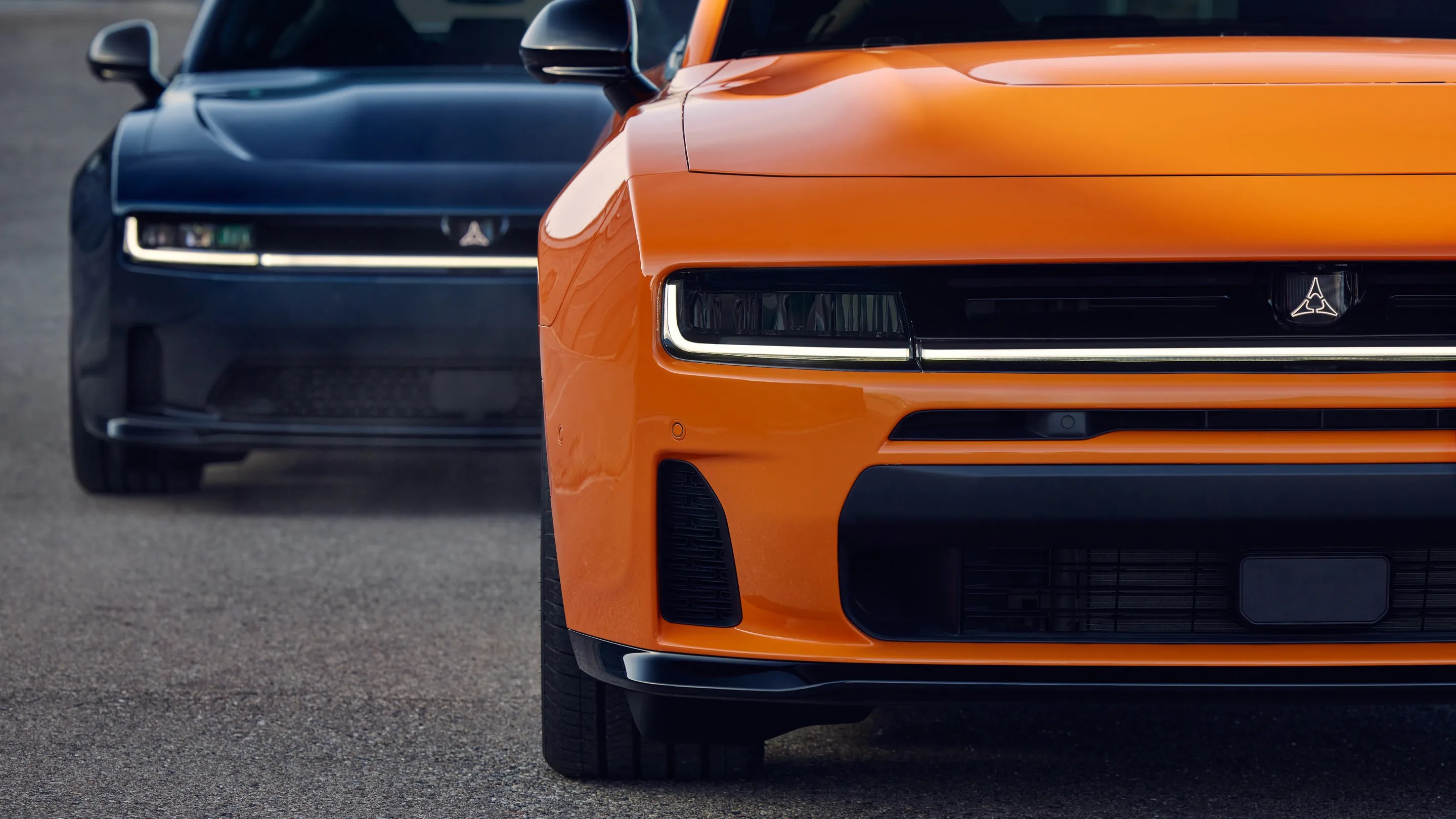 a photo of a pair of dodge muscle car close-up