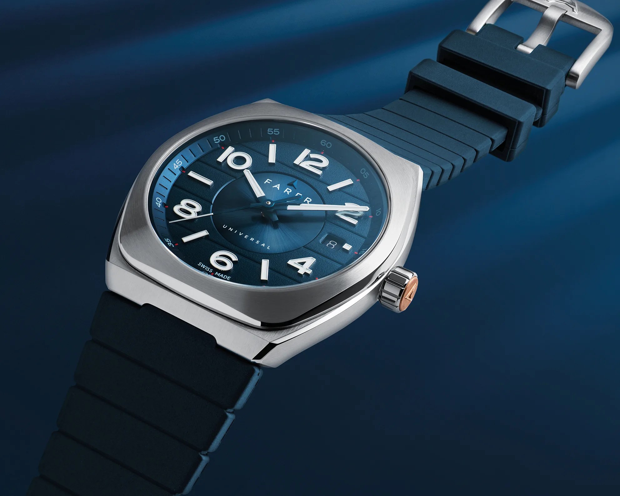 Square stainless steel wristwatch with a blue dial featuring large white Arabic numerals and a date window at the 3 o'clock position. The watch has a blue rubber strap with a silver buckle and a crown with a copper accent. The dial includes the text "FARER," "UNIVERSAL," and "SWISS MADE.