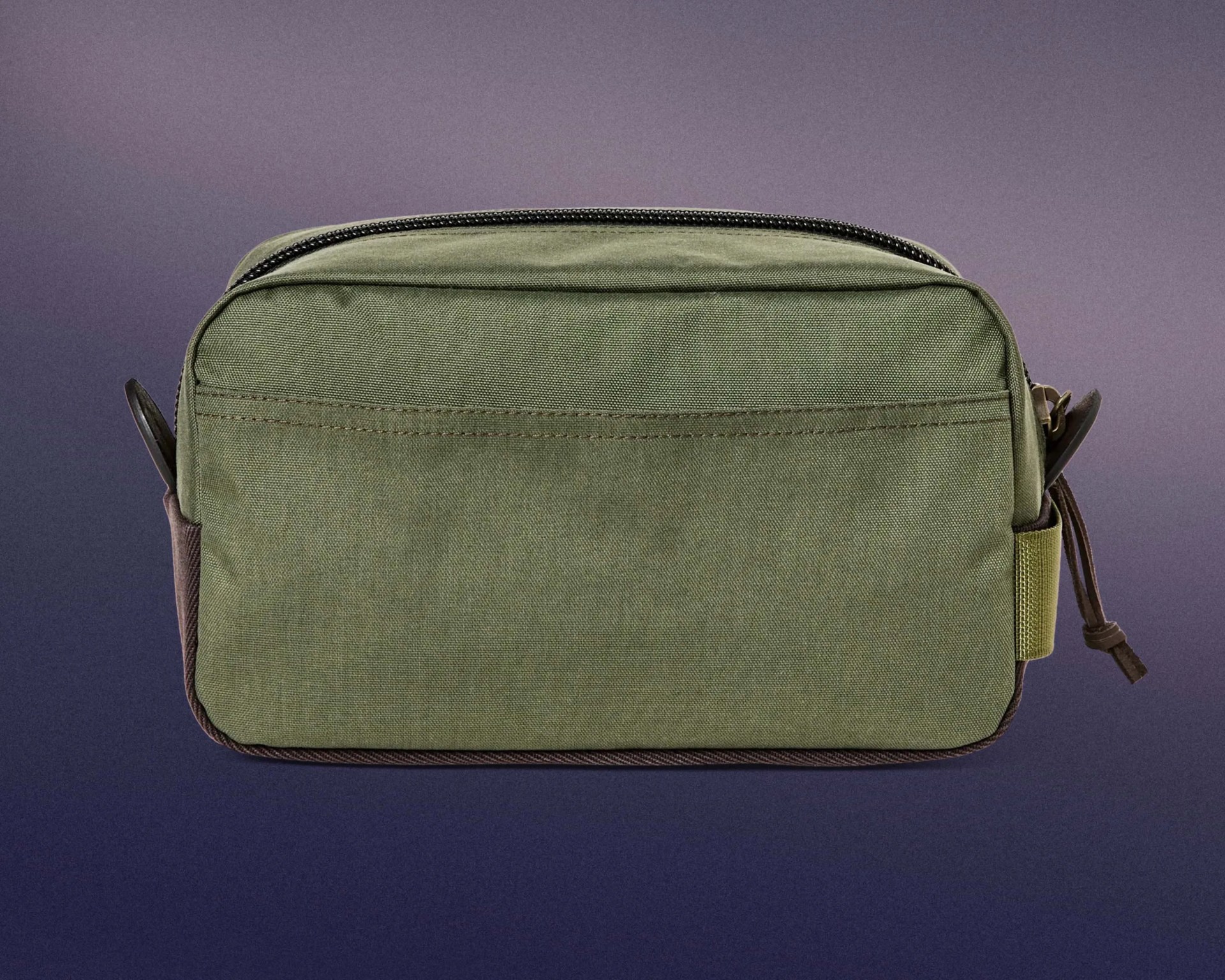 Olive green rectangular fabric pouch with a zipper on top and a small loop on the right side, set against a gradient purple and dark blue background.