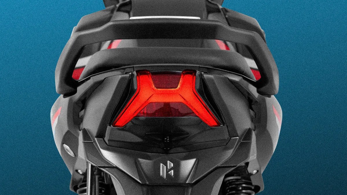 Rear view of a black motorcycle or scooter featuring a distinctive red Y-shaped tail light and a sturdy rear grab handle, set against a blue background.