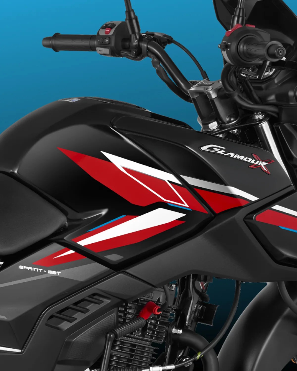 Close-up of a black motorcycle fuel tank with red, white, and blue angular graphics. The tank features the "Glamour X" logo in silver and red. The handlebar grips and control switches are visible above the tank. The text "Sprint - 22T" is printed on the side panel below the tank.