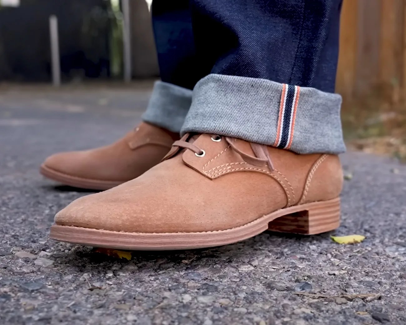 a man wearing tan boots