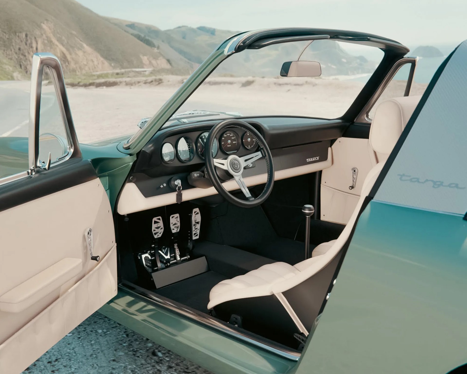 a photo of the interior of a porsche 912 restomod with cream and black upholstery