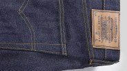 Dark blue denim fabric with yellow stitching, featuring a back pocket and a tan leather patch label. The label reads "LEVI STRAUSS & CO," "GENUINE QUALITY CLOTHING," "MADE IN JAPAN," and includes the iconic Levi's two-horse logo.