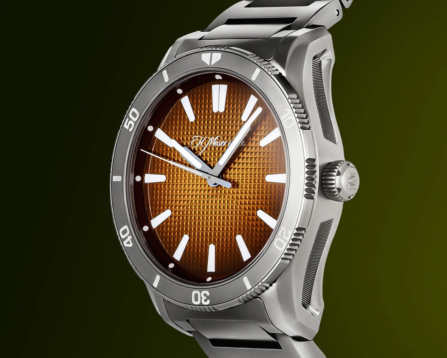 Silver wristwatch with a textured orange-brown dial, white hour markers, and white hands. The bezel is silver with white numerals and markers, and the watch has a matching silver metal bracelet. The crown features an engraved logo.