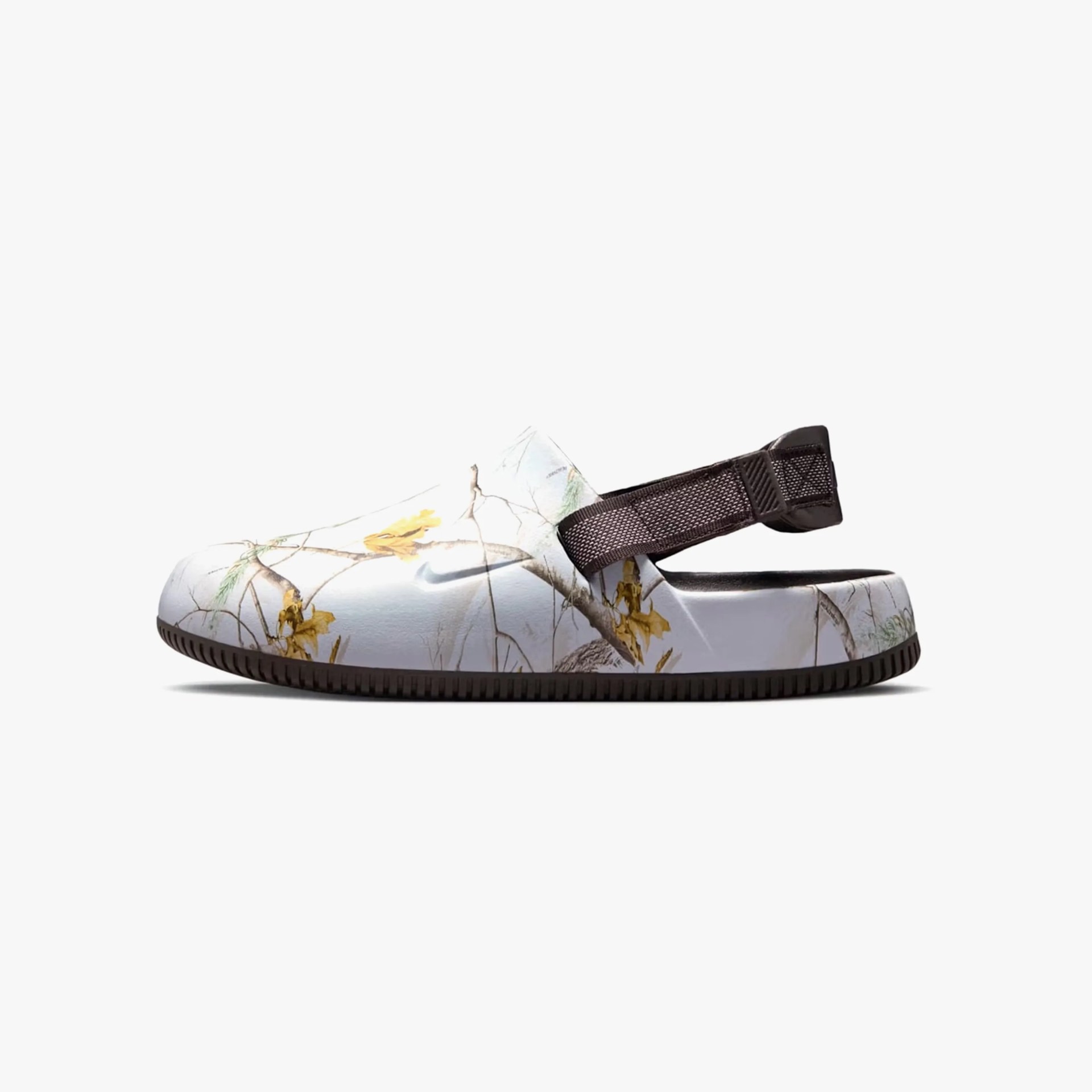 White slip-on clog with a nature-inspired print featuring branches and yellow flowers, a black adjustable heel strap, and a black sole.
