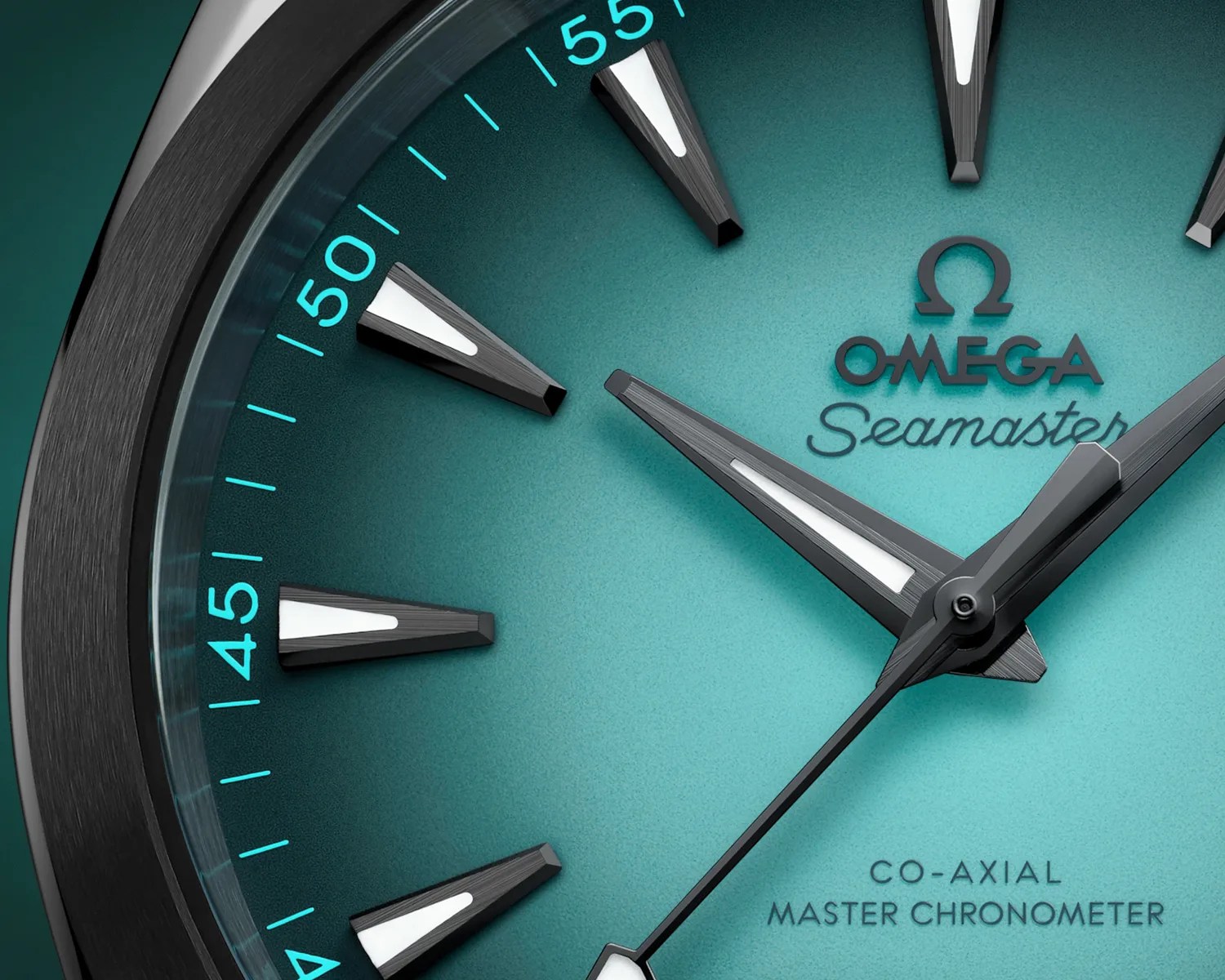 Close-up of an Omega Seamaster watch face with a teal gradient dial, black and white hour markers, and black hands. The text "OMEGA Seamaster" and "CO-AXIAL MASTER CHRONOMETER" is visible on the dial. The outer edge features minute markers in light blue.