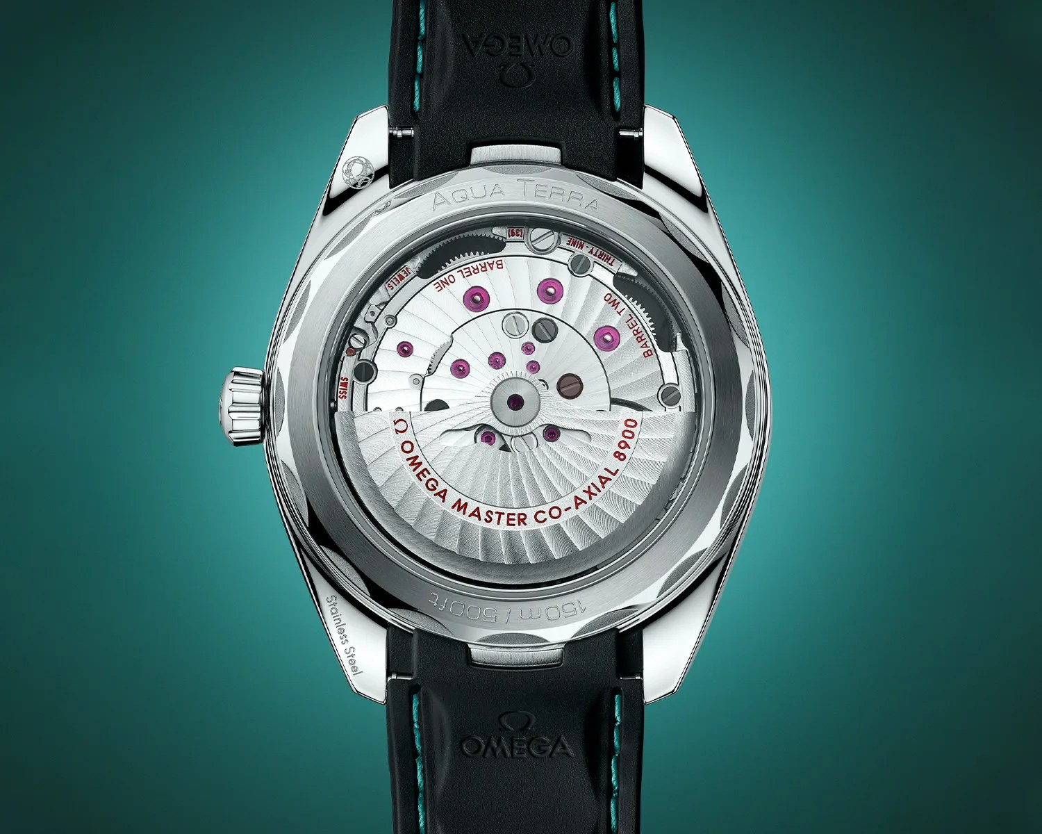Back view of an Omega Aqua Terra watch showcasing its intricate mechanical movement labeled "Omega Master Co-Axial 8900." The watch features a stainless steel case, visible gears, and purple jewel bearings, with a black leather strap embossed with the Omega logo and teal stitching. The case back is engraved with "Aqua Terra" and "150m / 500ft.