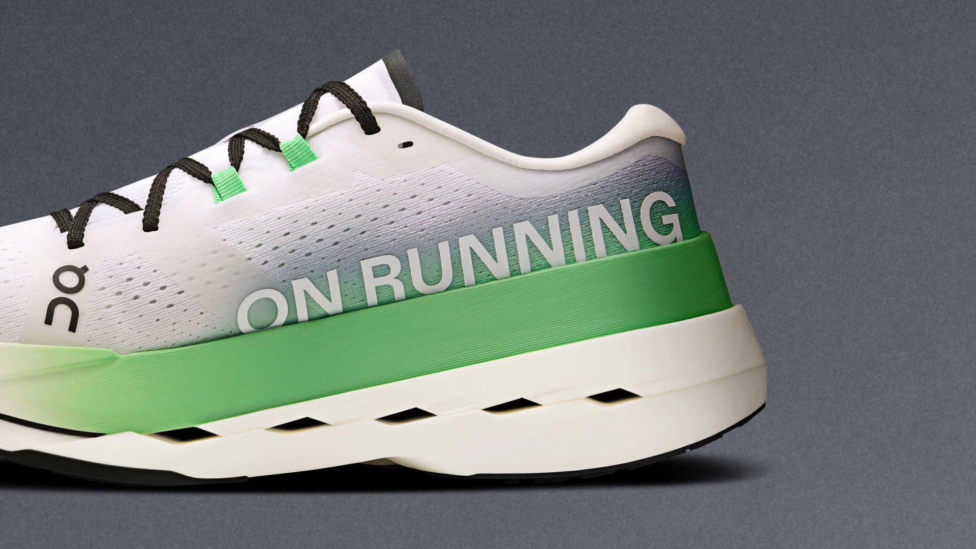 White and green running shoe with black laces, featuring the text "ON RUNNING" on the side and a gradient design from white to green on the midsole. The shoe has a perforated upper and a thick, cushioned sole with cut-out details.