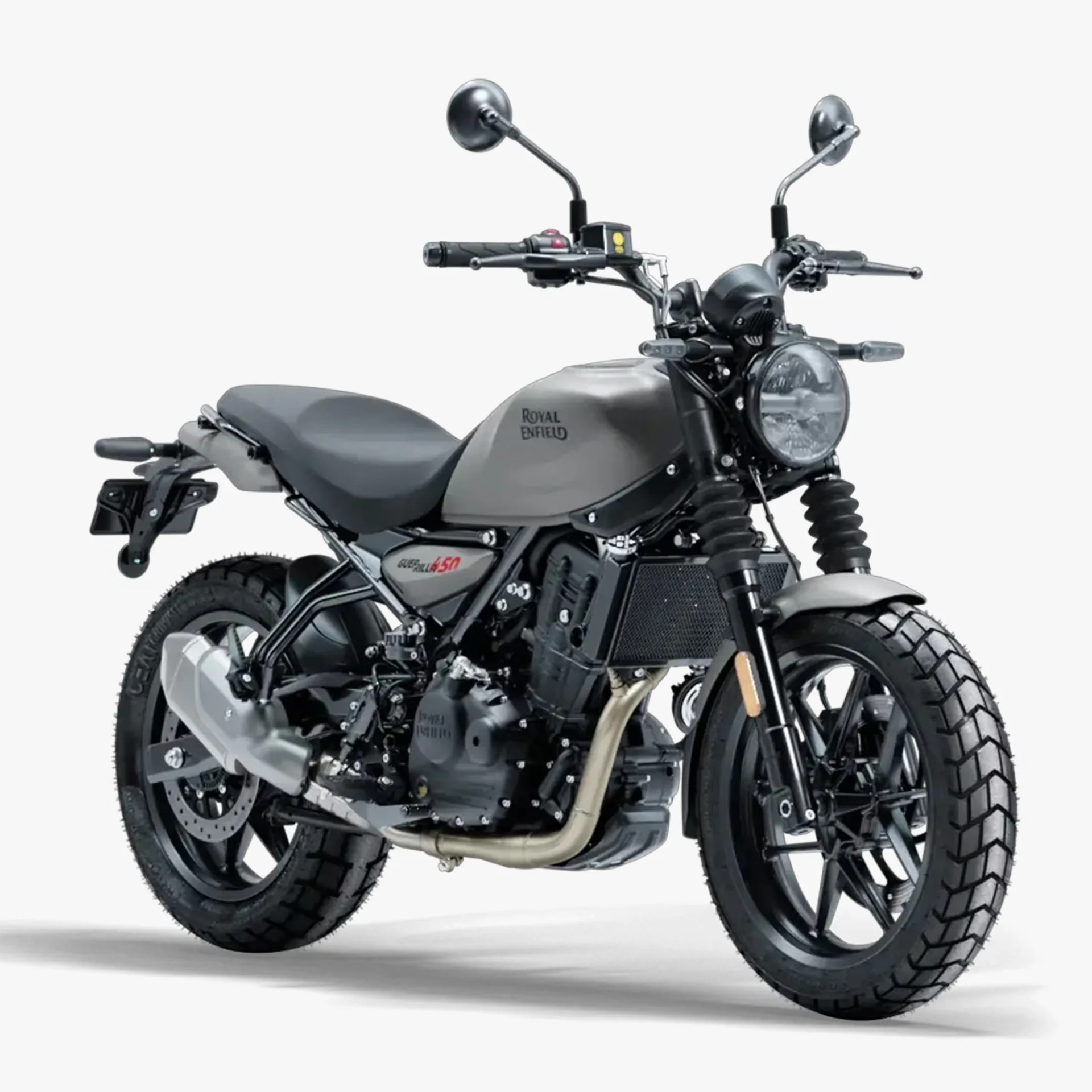 Royal Enfield Scram 450 motorcycle in matte grey with black accents, featuring a round headlight, knobby tires, dual rearview mirrors, and a single seat. The bike has a rugged, modern scrambler design with visible exhaust pipes and a compact frame.