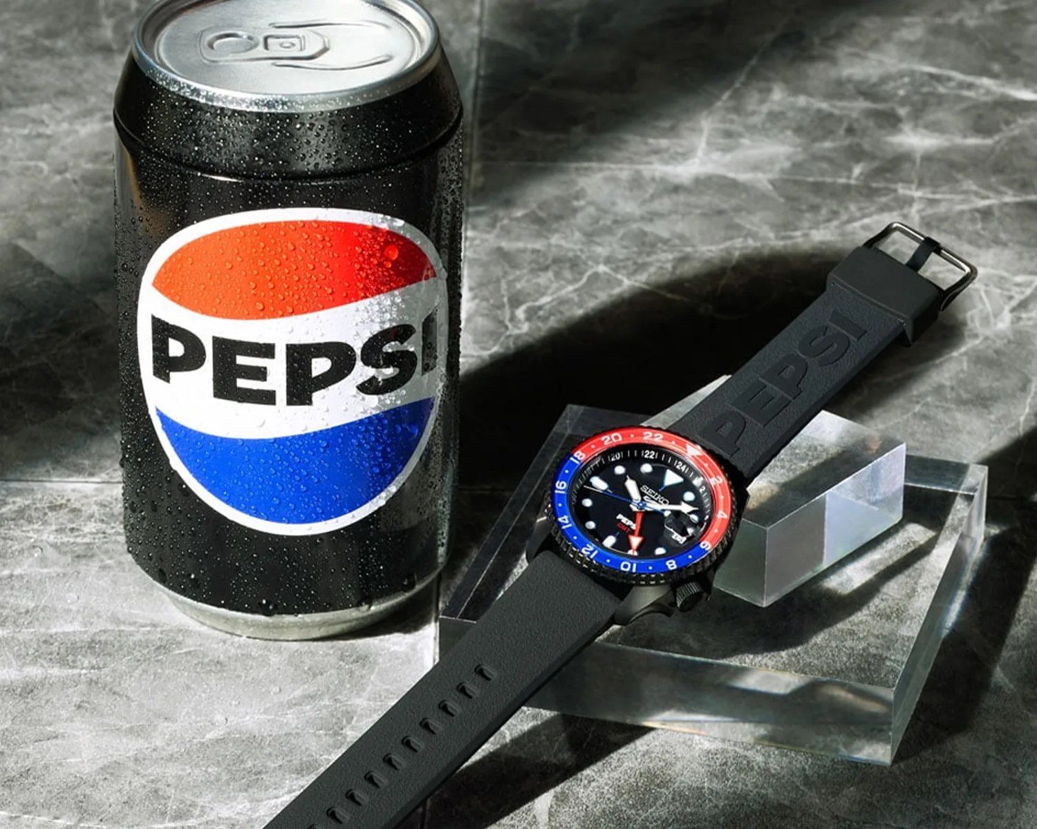 a seiko watch next to a pepsi can