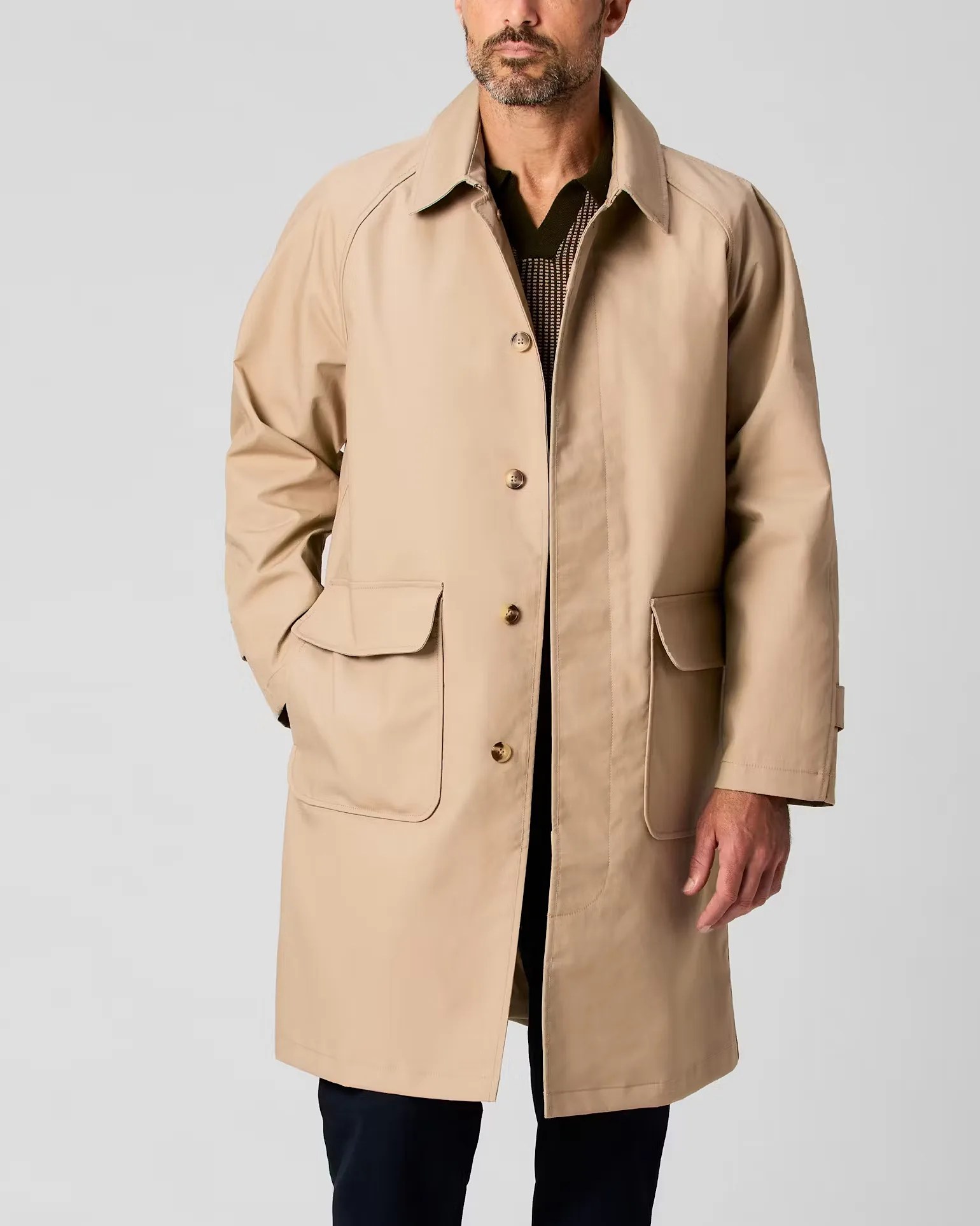 a man in a khaki Wills trench coat