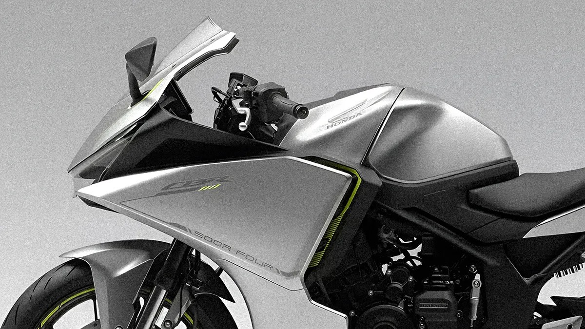 Close-up of a silver Honda motorcycle focusing on the front and side fairing, showing the "CBR" and "500R FOUR" markings. The bike features a sleek, aerodynamic design with a tinted windshield, side mirrors, and a visible front tire with a yellow accent on the rim. The seat and part of the engine are also visible.