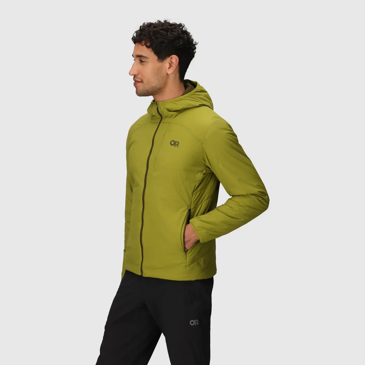 Light green hooded jacket with a front zipper, worn by a man with his right hand in the side pocket. The jacket has a small "OR" logo on the left chest. The man is also wearing black pants with a matching "OR" logo on the left thigh.