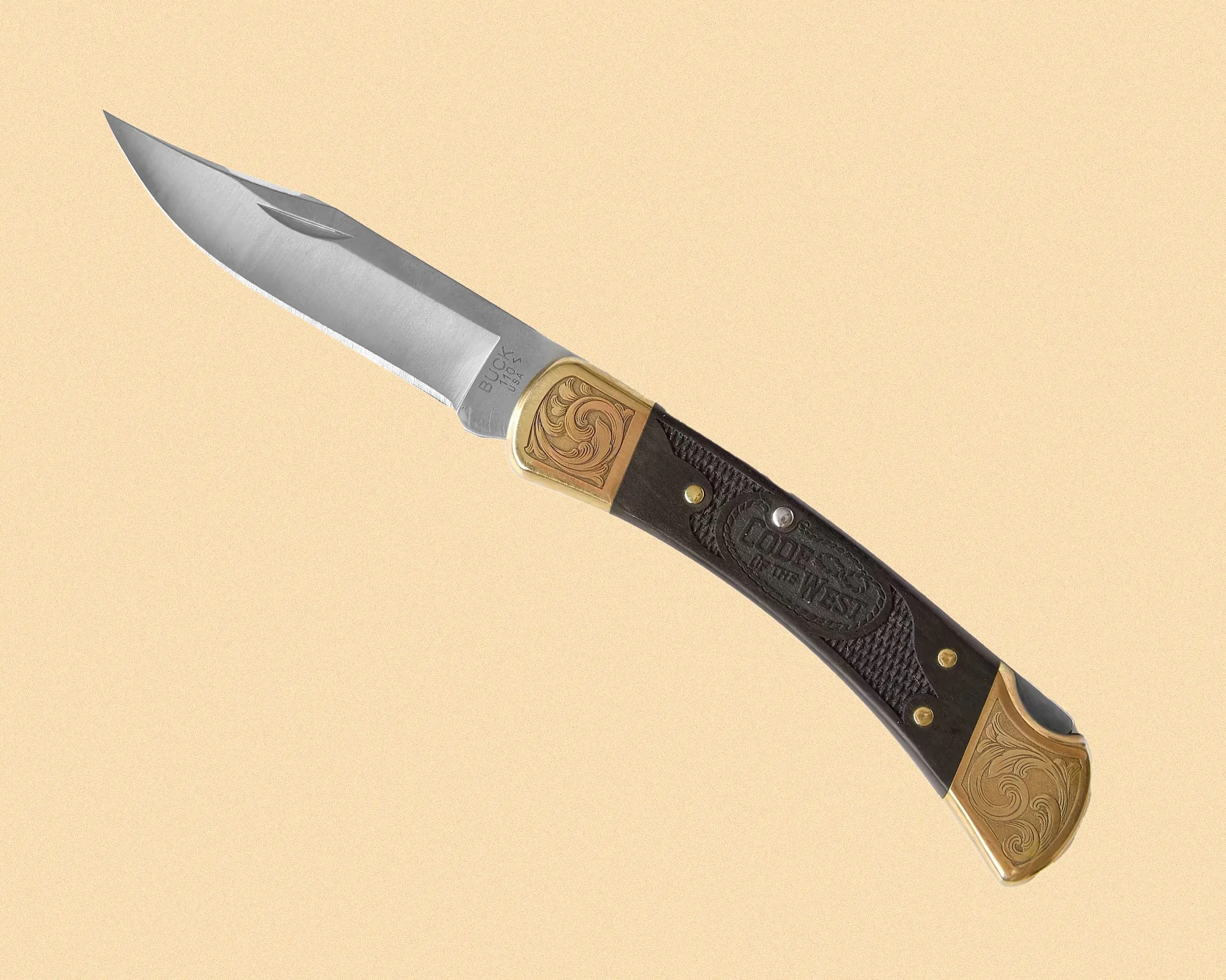 Folding pocket knife with a stainless steel blade marked "BUCK 110 USA." The handle is dark with brass bolsters featuring engraved swirl designs and an embossed "Colors of the West" logo. The knife has a classic, vintage style.