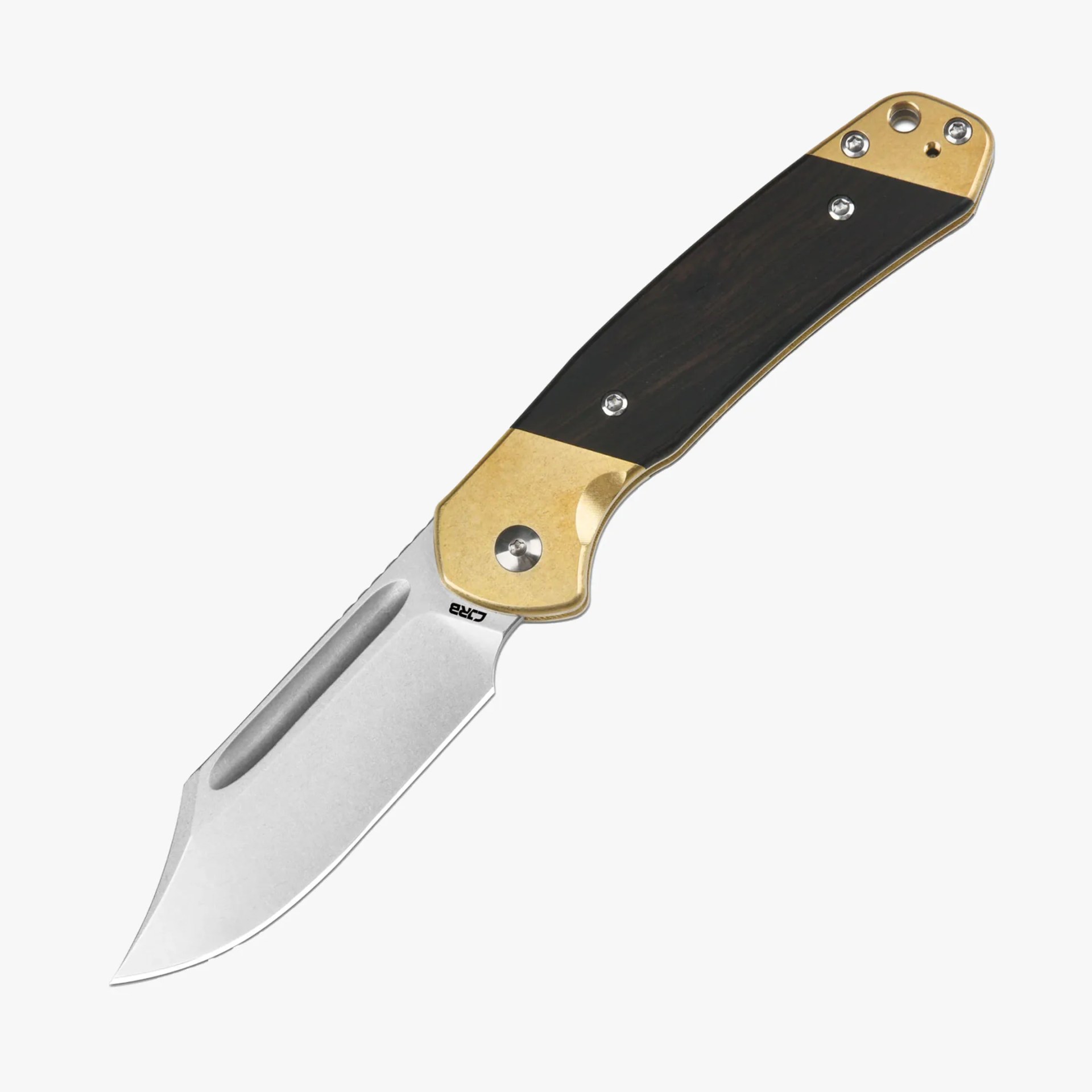 Folding knife with a silver blade featuring a groove near the spine and a sharp, slightly curved tip. The handle has a two-tone design with brass-colored metal at both ends and a dark wood or wood-like material in the middle, secured with multiple screws. The knife has a sturdy, ergonomic shape.