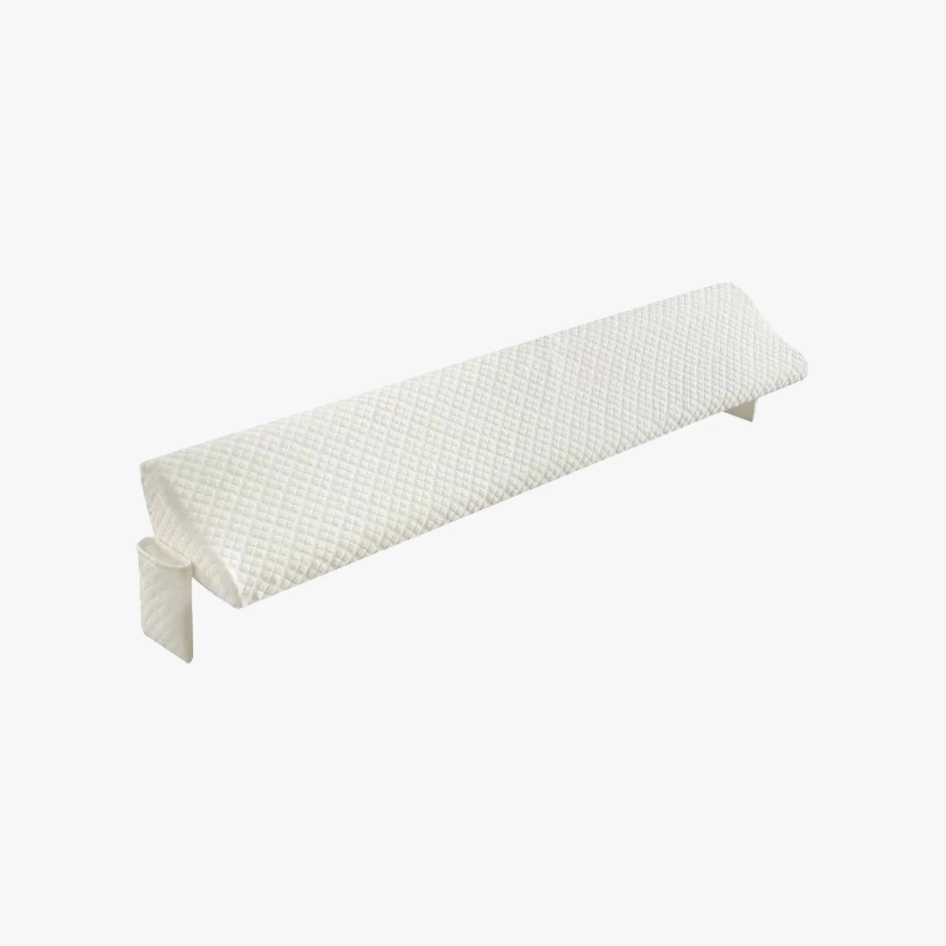 Long, white, quilted armrest cushion with a triangular shape and two fabric straps for securing it to a surface.