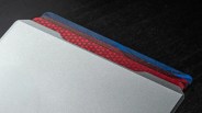 Three file folders with colored tabs are shown, partially stacked. The front folder is gray, the middle folder has a red tab with a star pattern, and the back folder has a blue tab. The folders are placed on a dark surface.